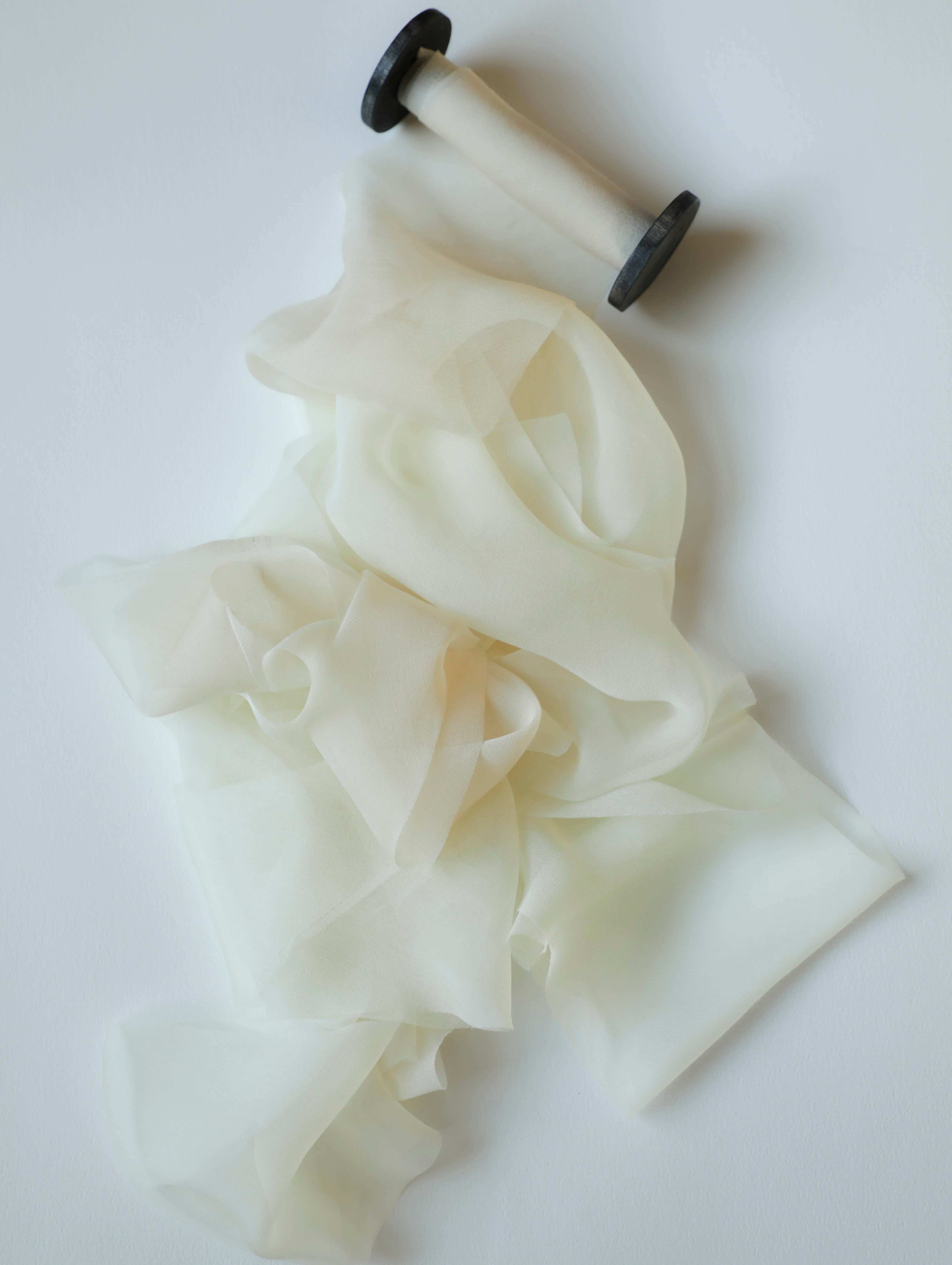 White ruffled silk ribbon on a white background
