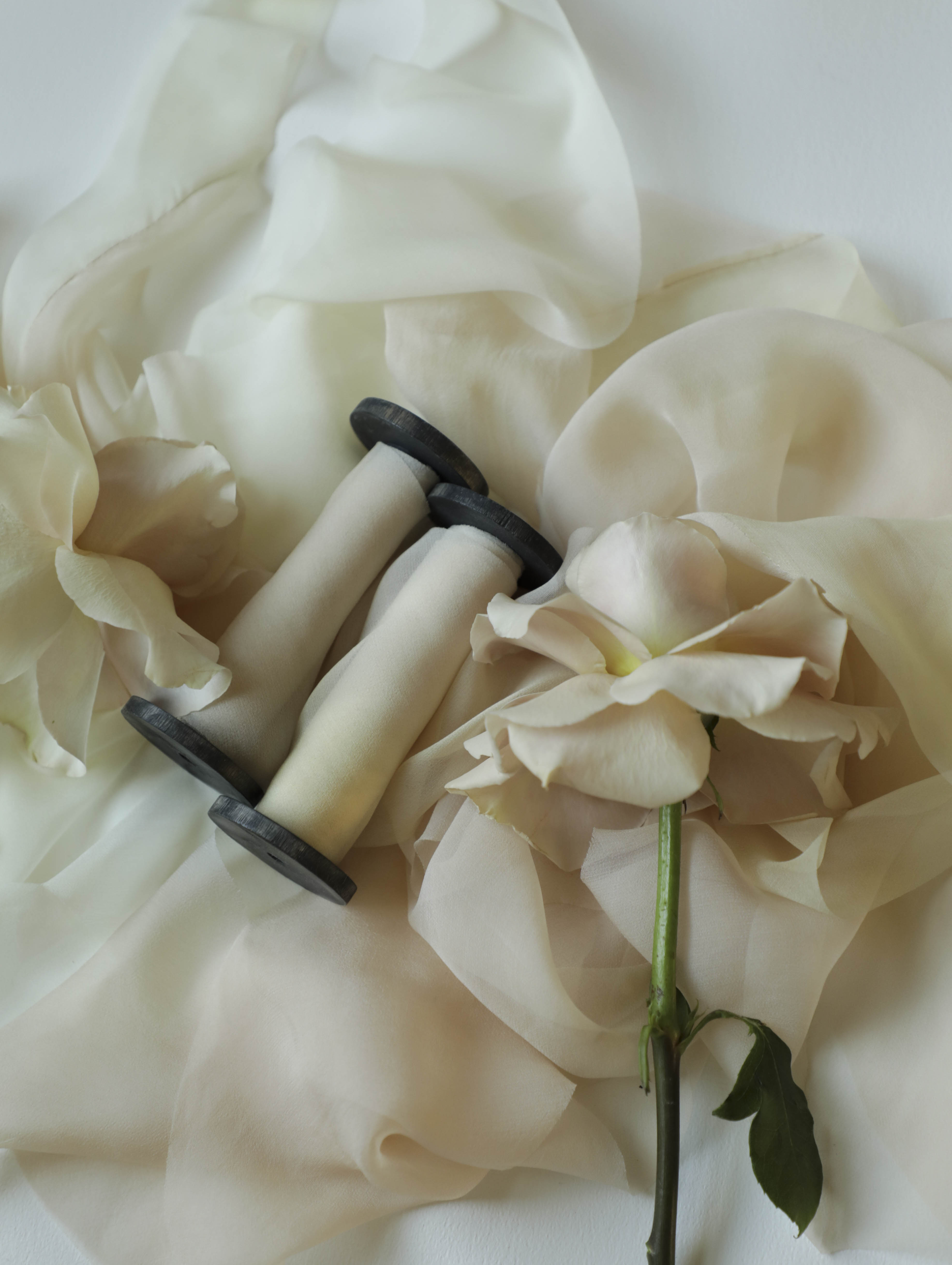 Vintage-style sewing tool on a soft fabric background