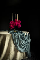 Table setting with pink flowers and candles on a dark background