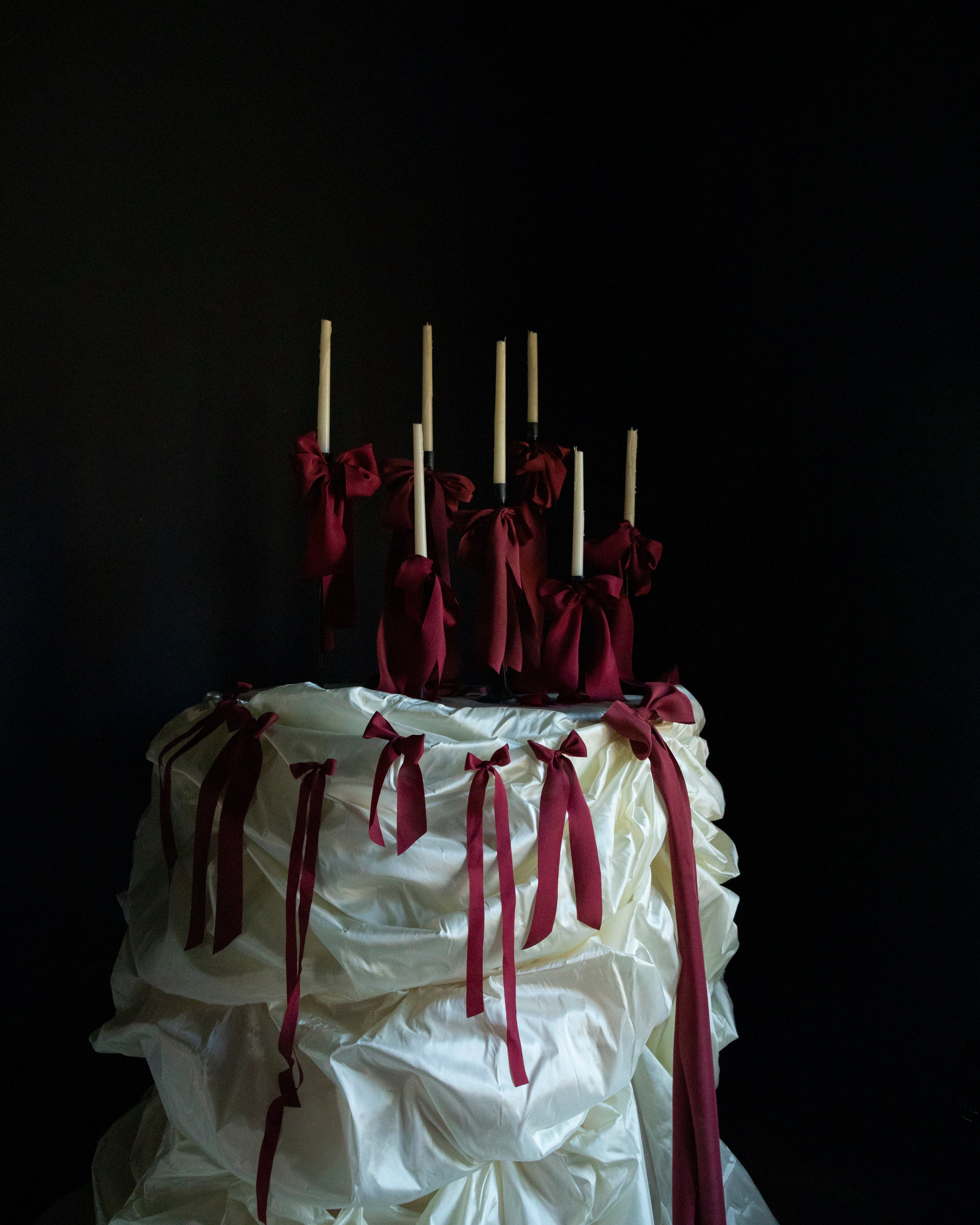 luxury wedding cake table with red ribbon bows