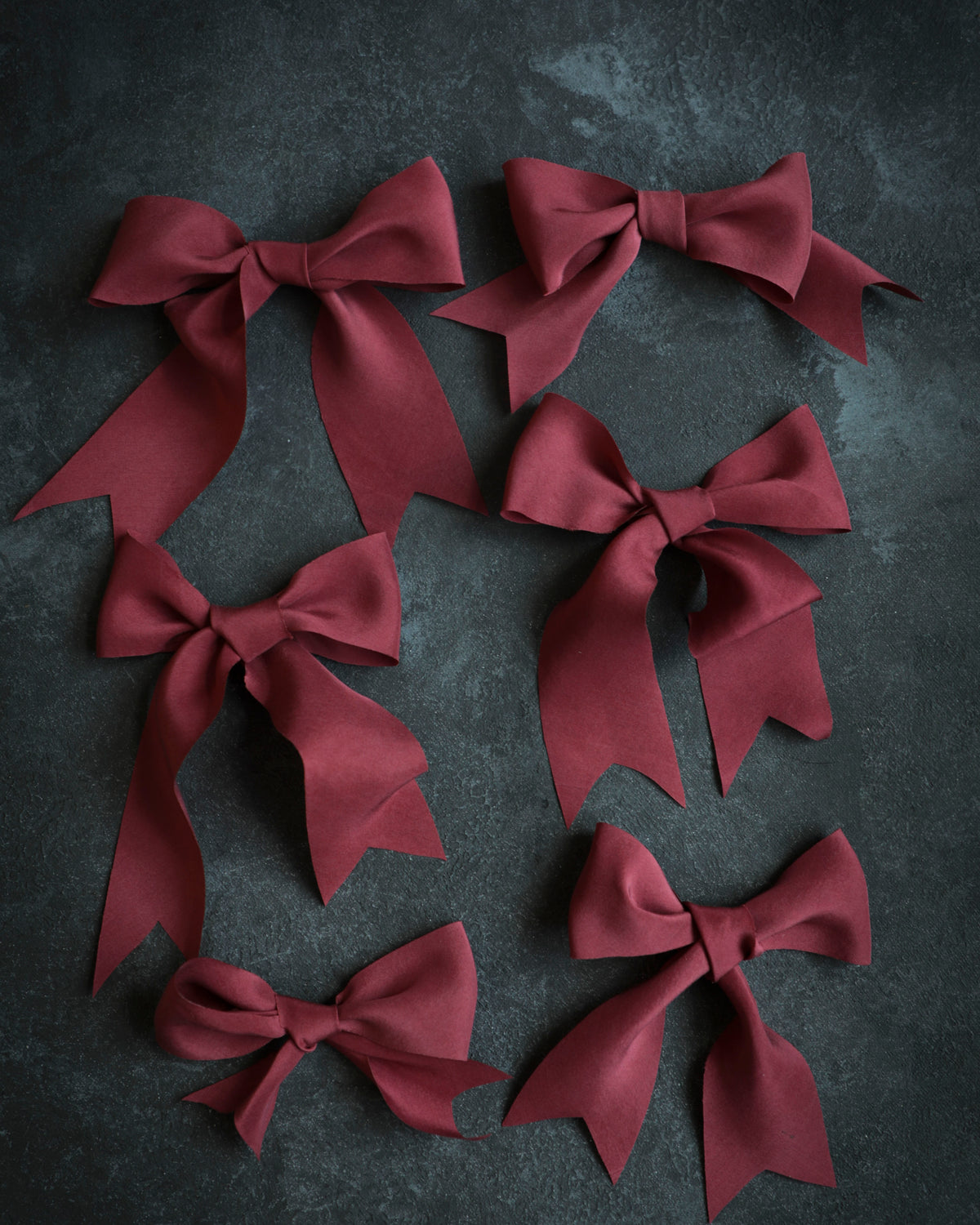 red ribbon bows against black background