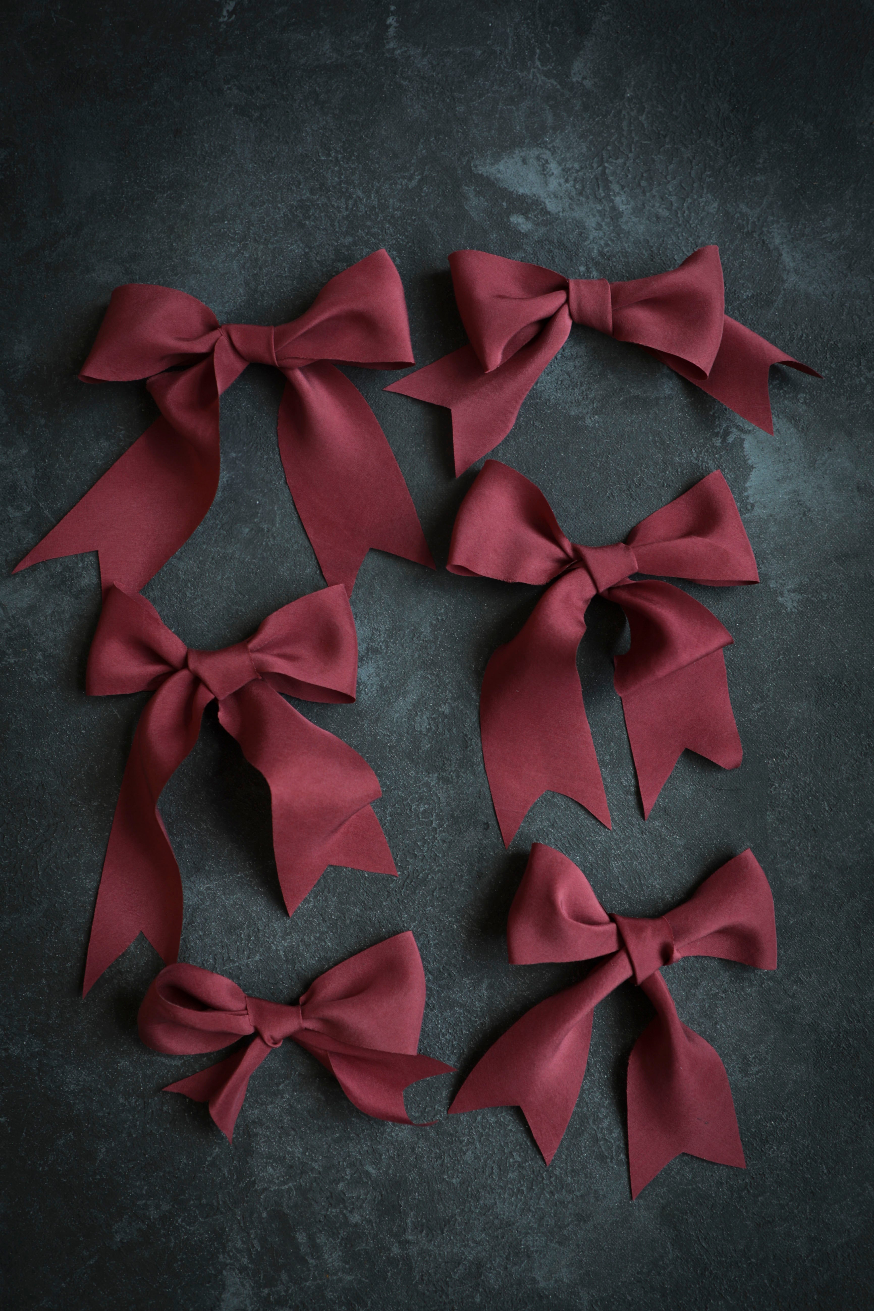 red ribbon bows against black background