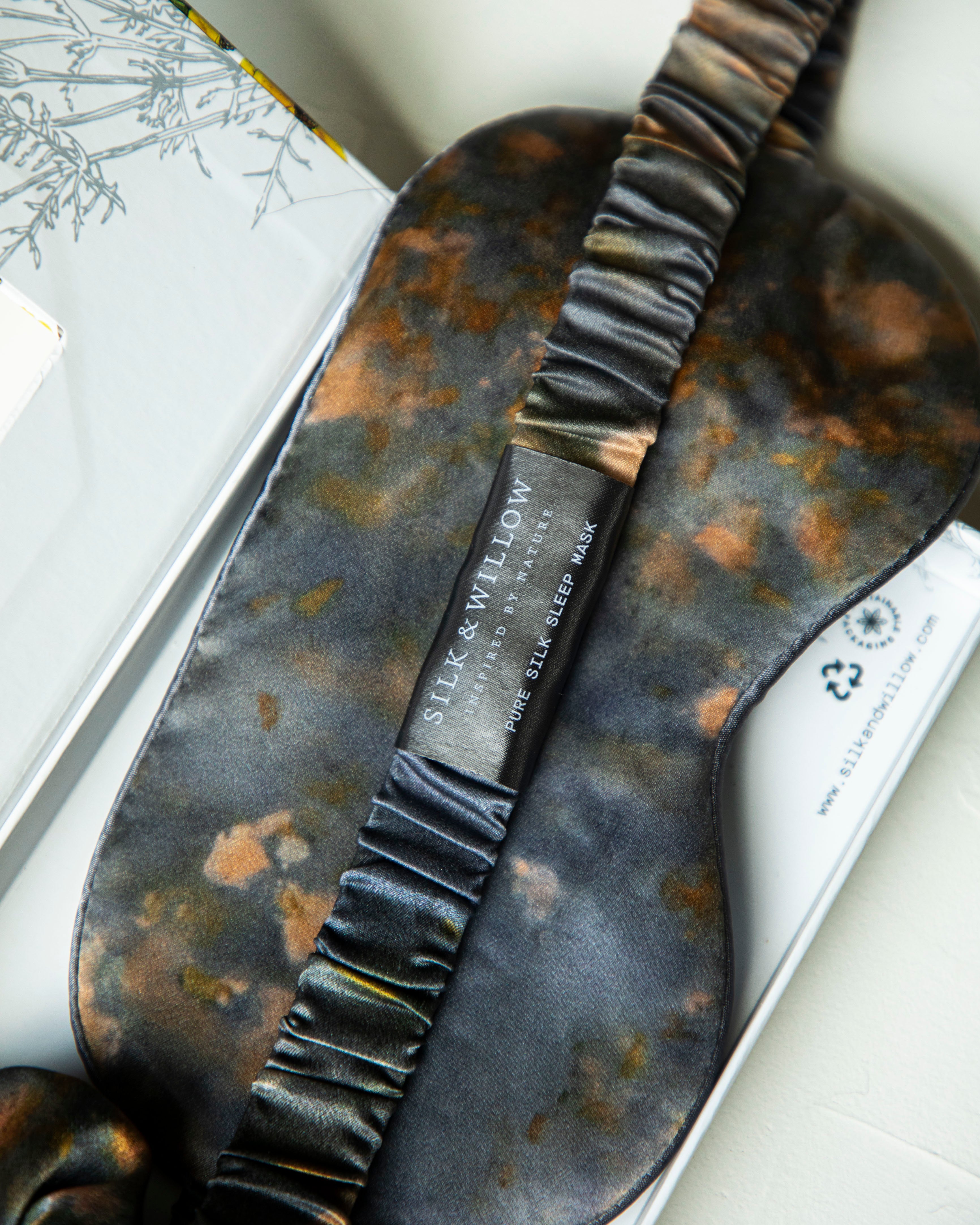 close-up of silk sleep eye mask with silk and willow branding.