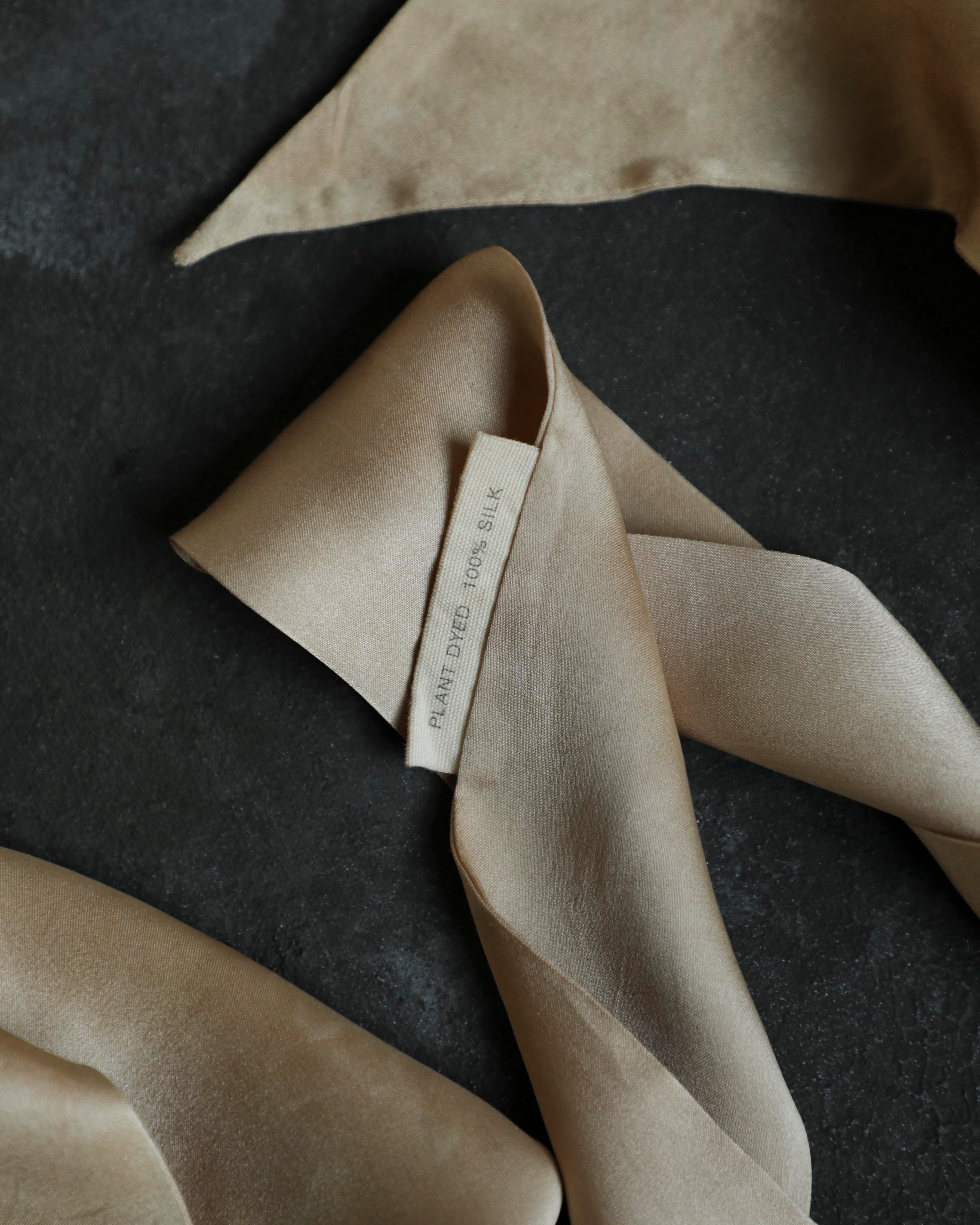 Beige fabric with a tag on a dark surface