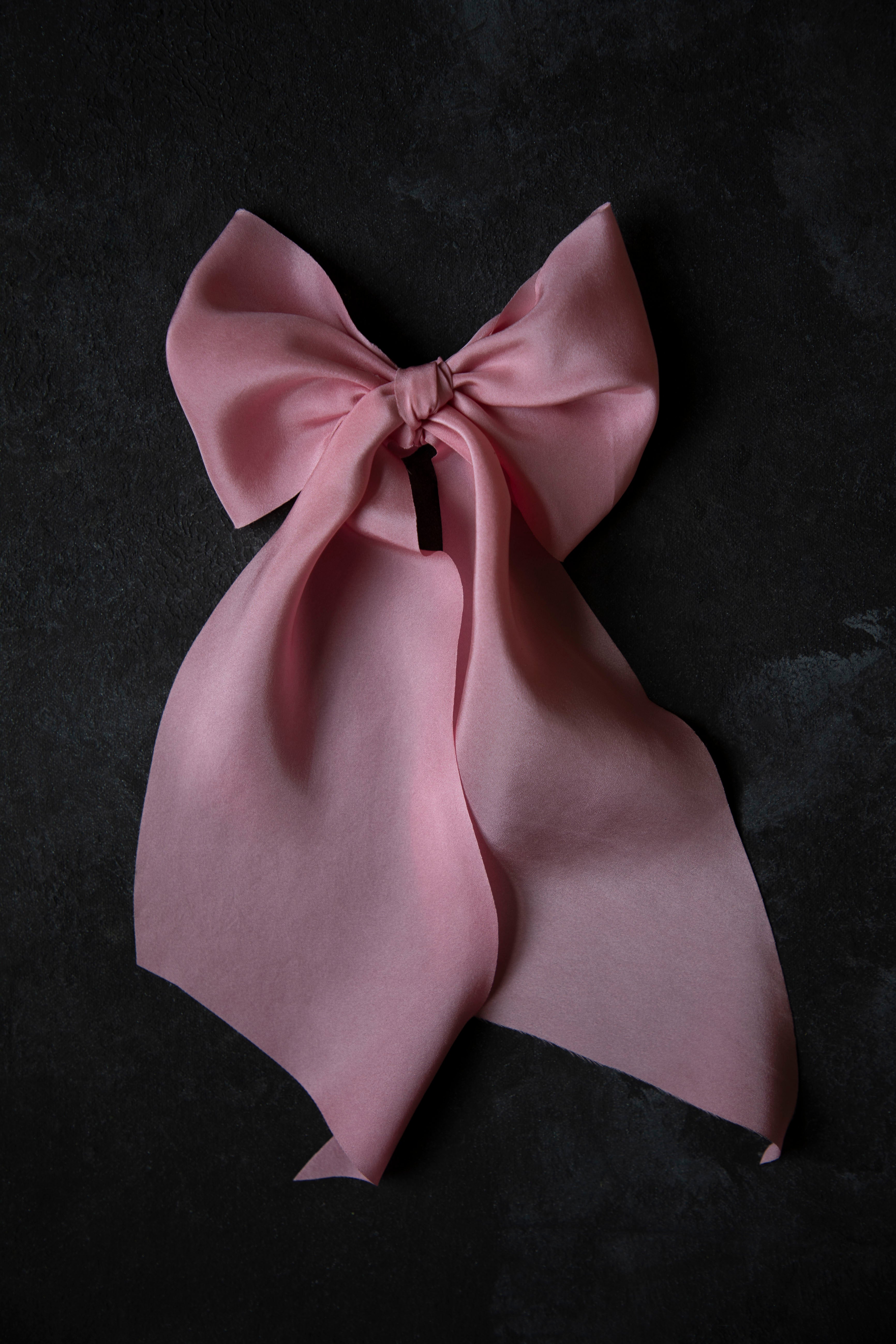Pink bow on a black background