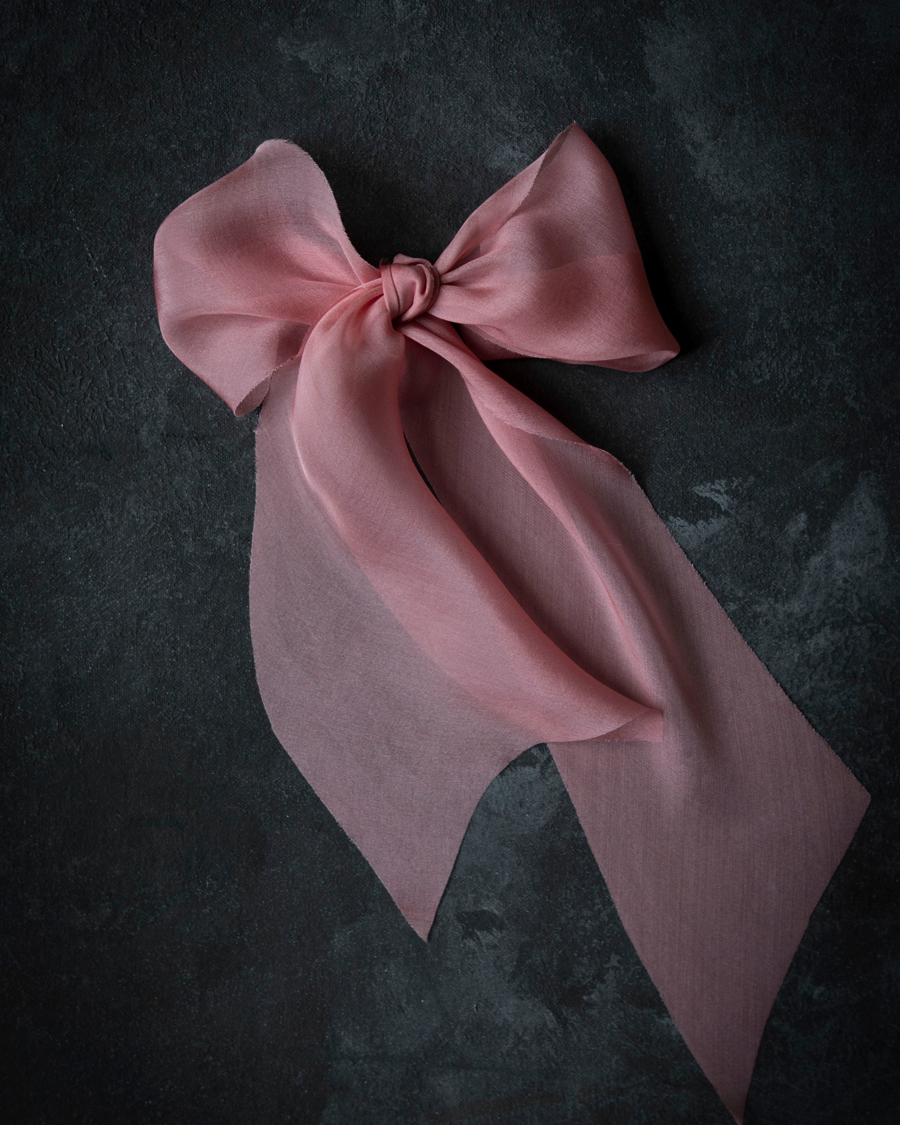 Pink bow on a dark textured background