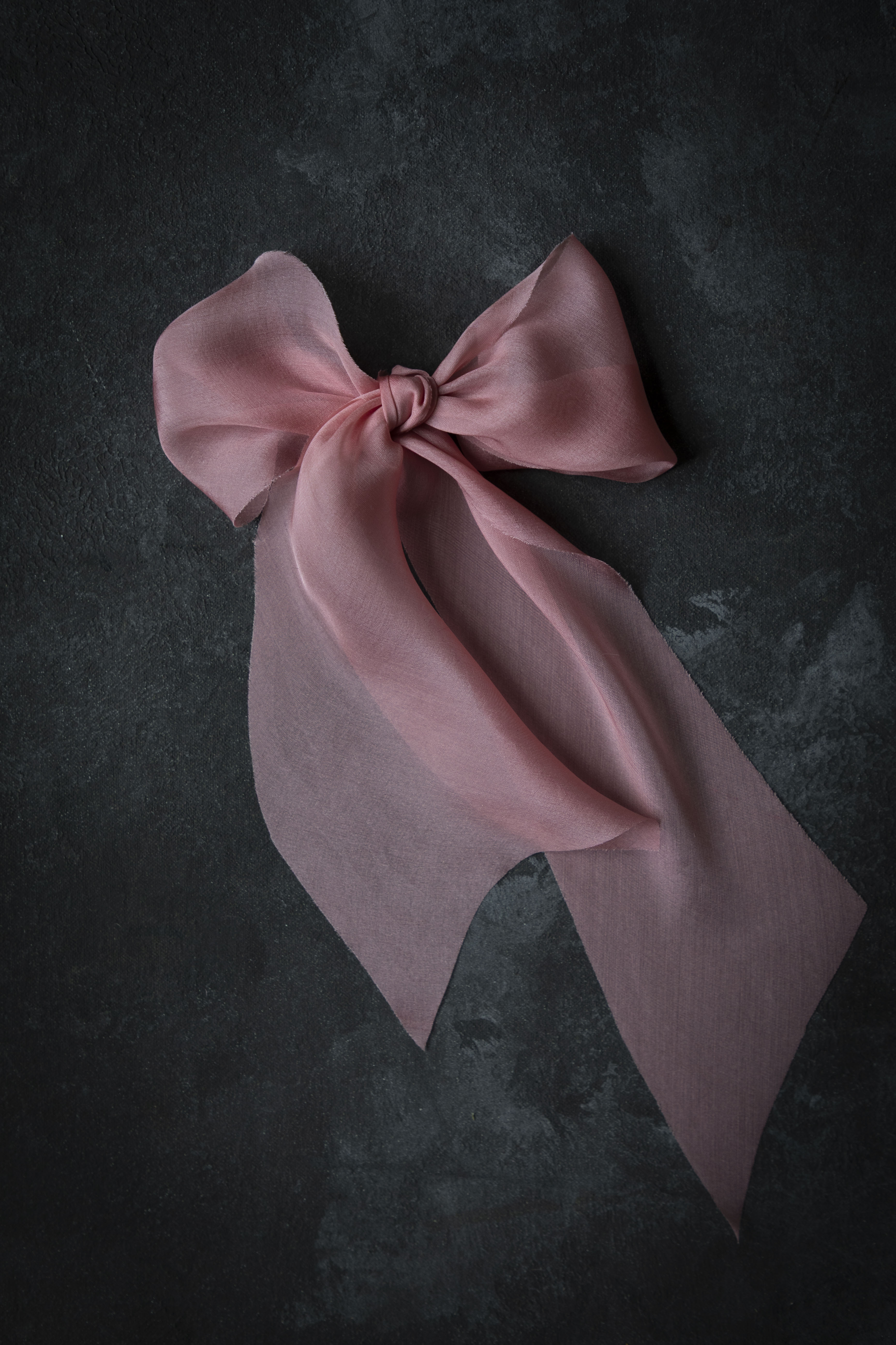 Pink bow on a dark textured background