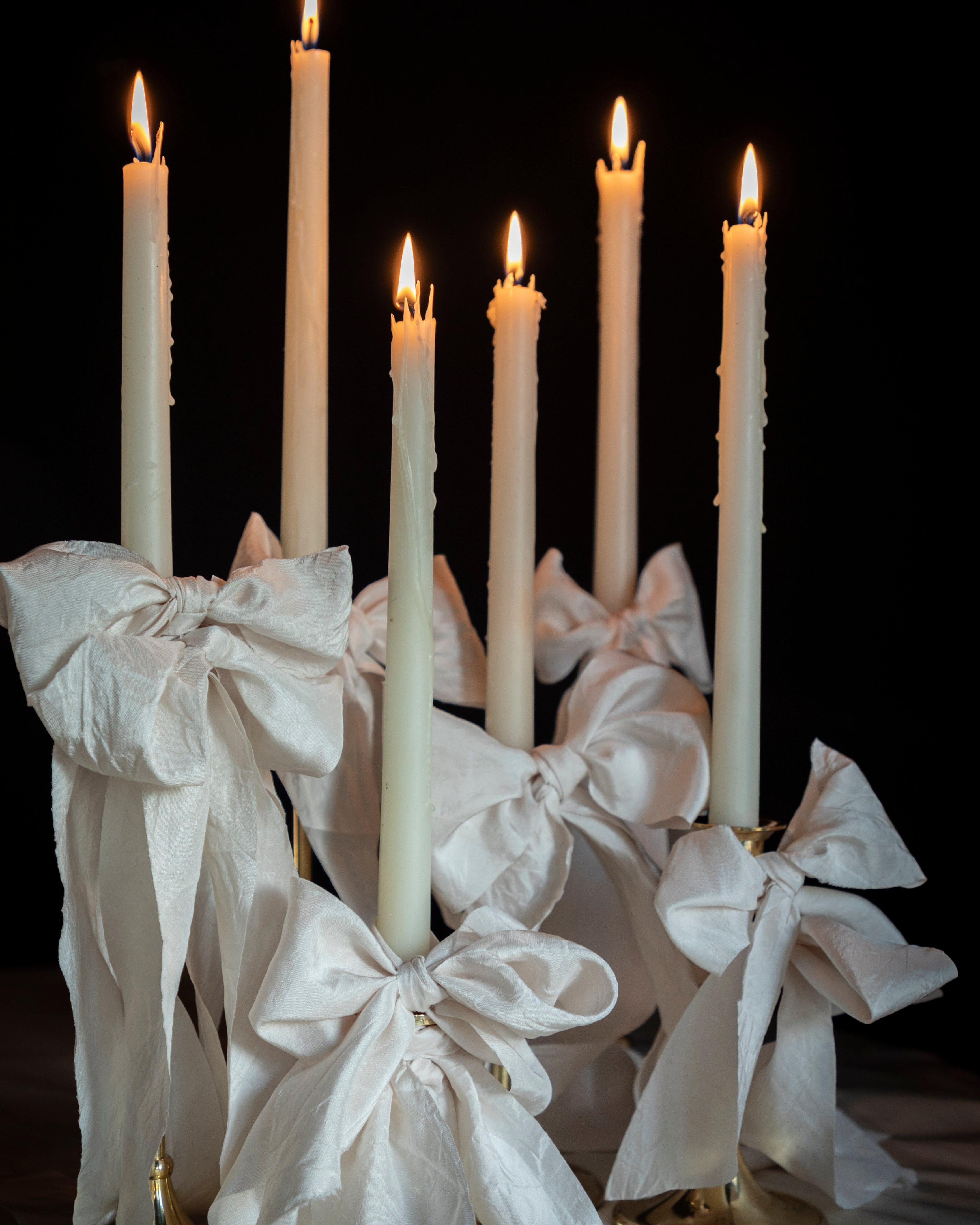 ribbon bows on candles. Weddding table designs by wedding stylist shellie pomeroy