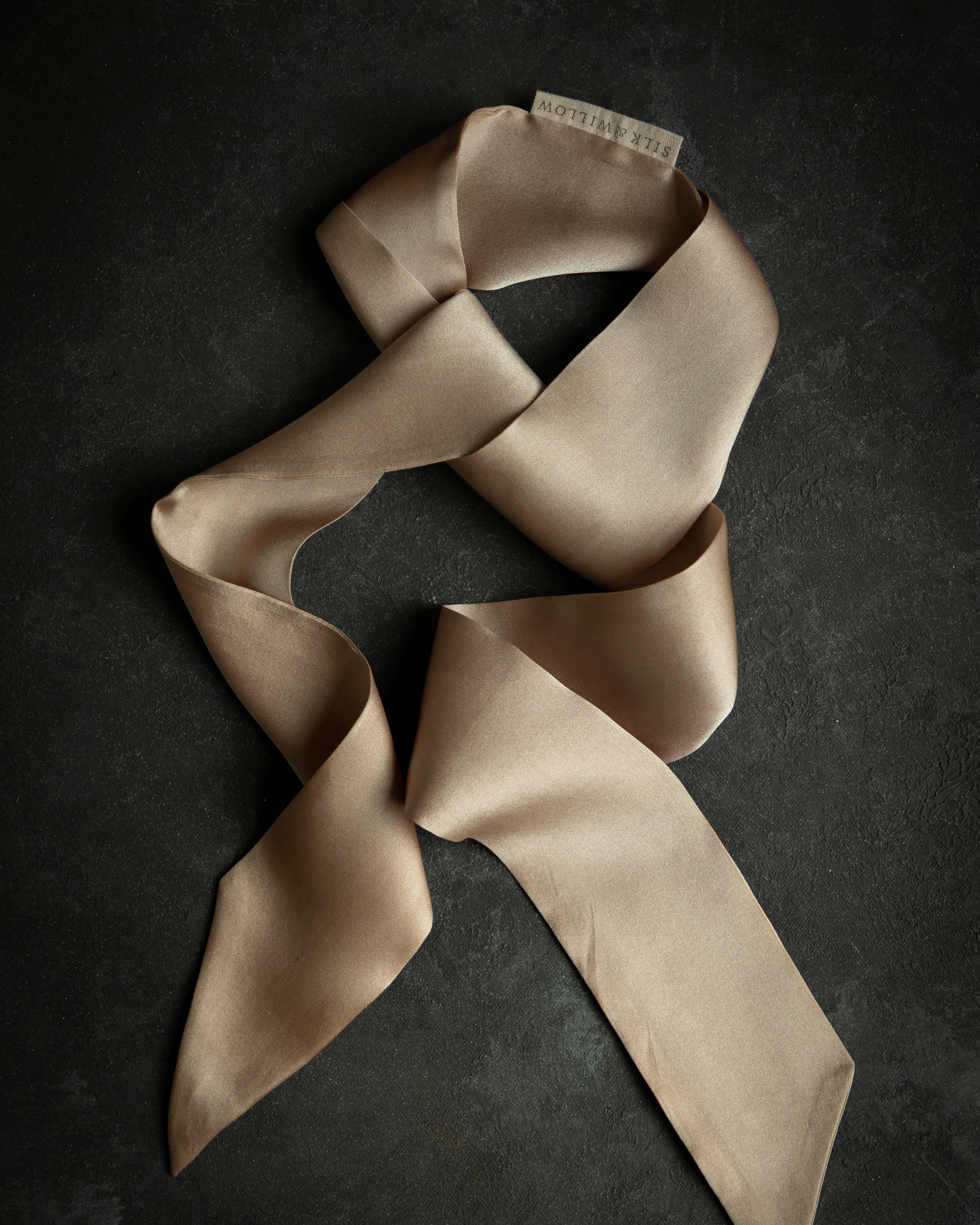 blush twilly on black background