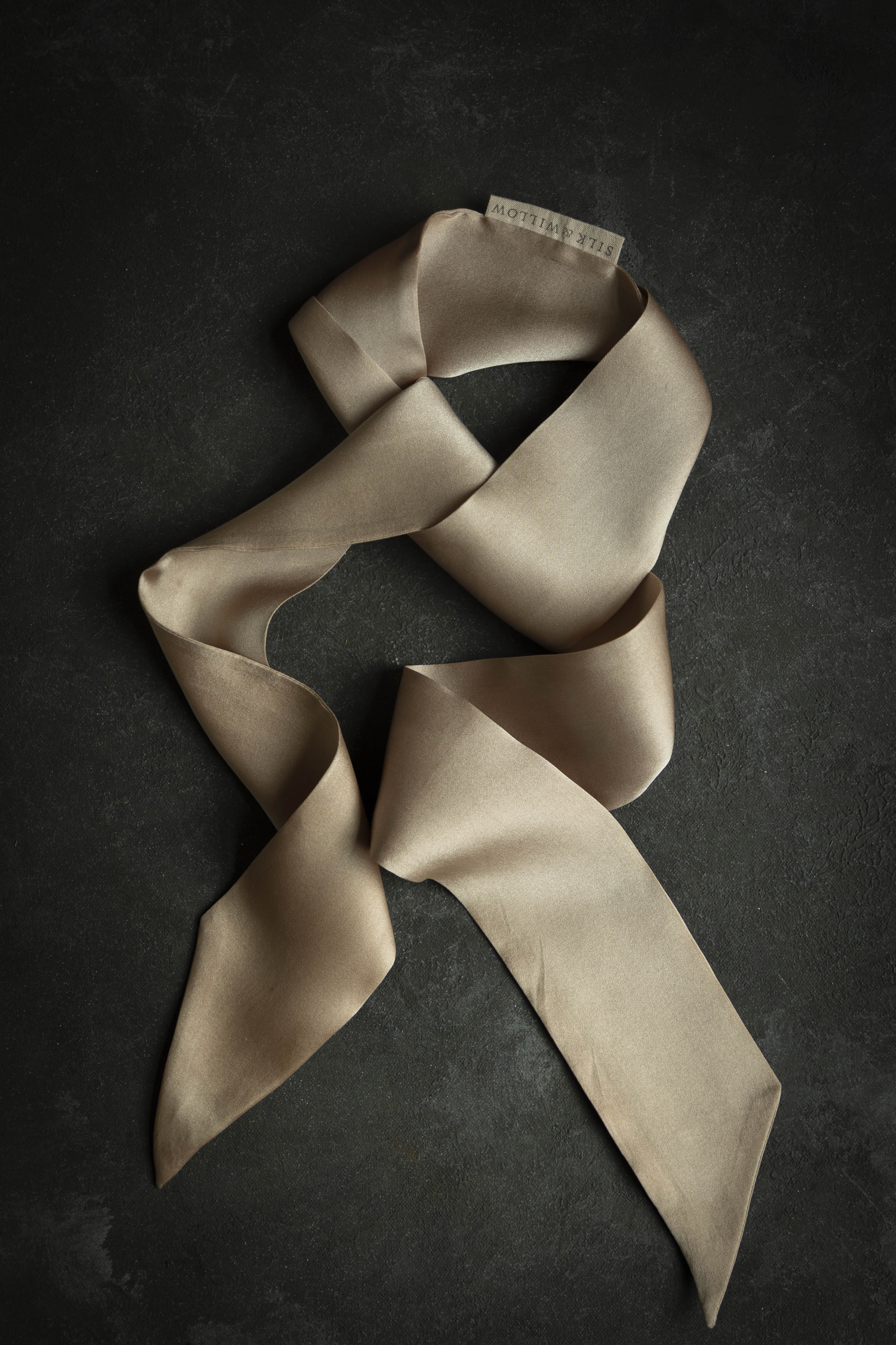 blush twilly on black background