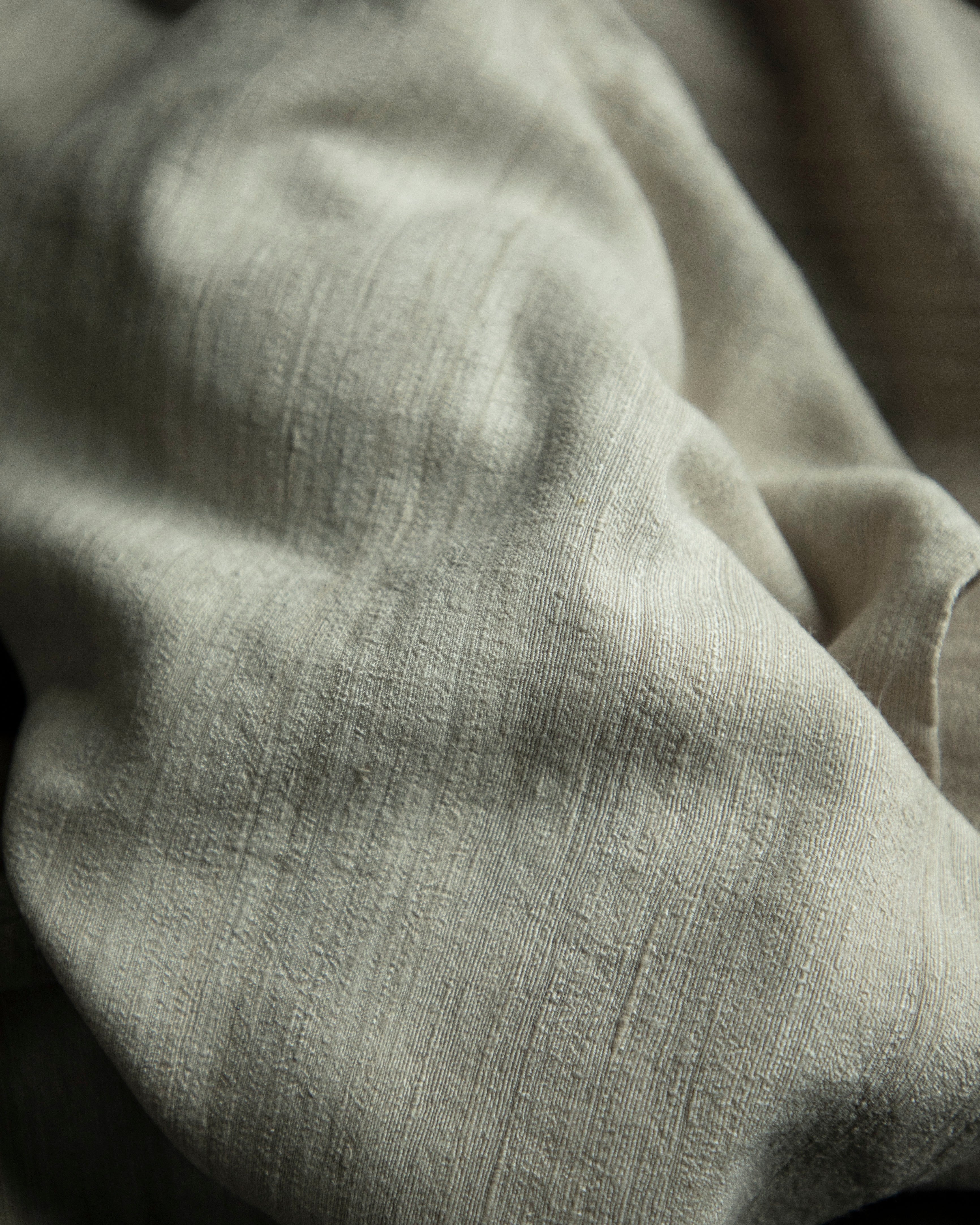 Close-up of textured gray fabric with folds