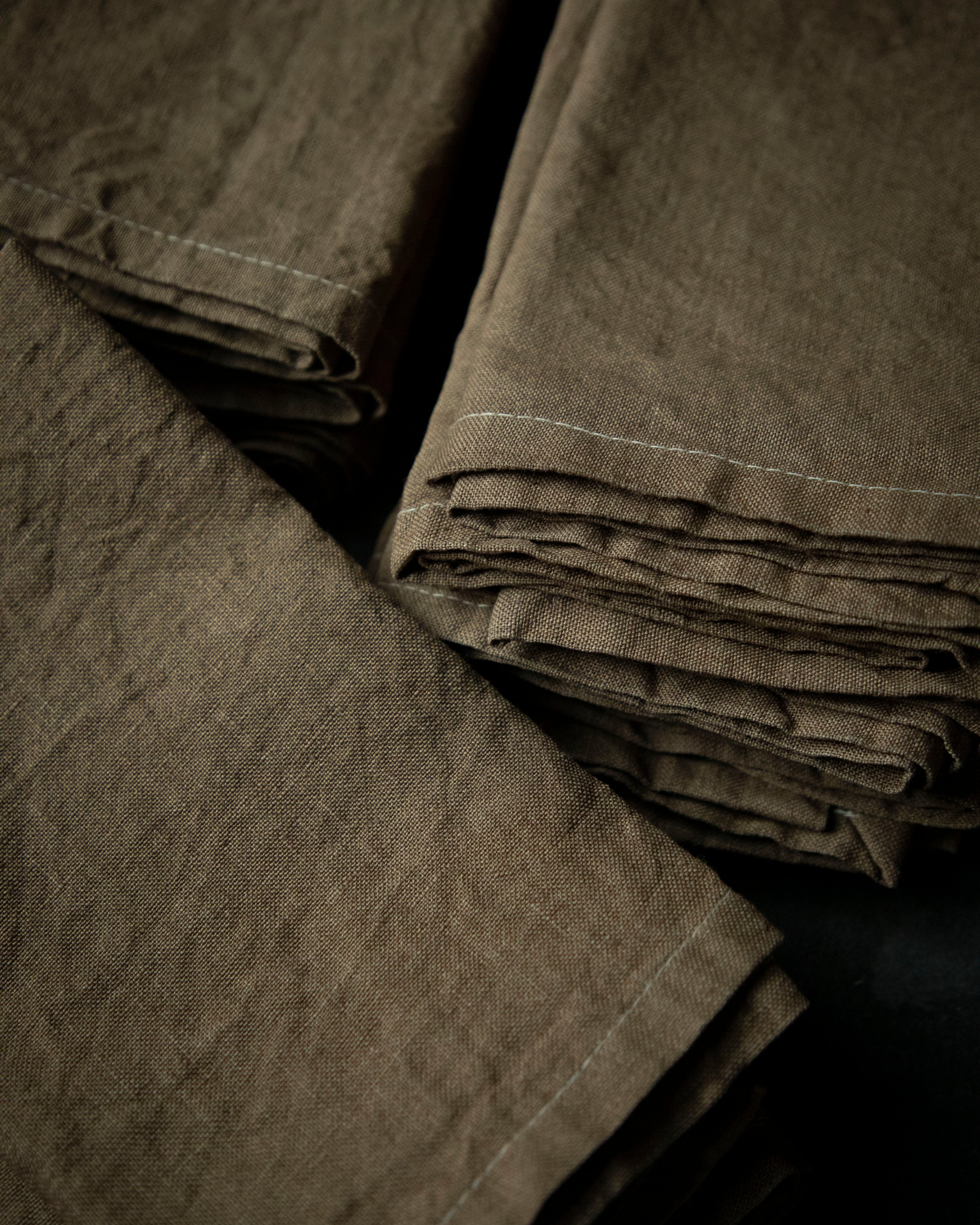 Stack of folded brown napkins on a black background