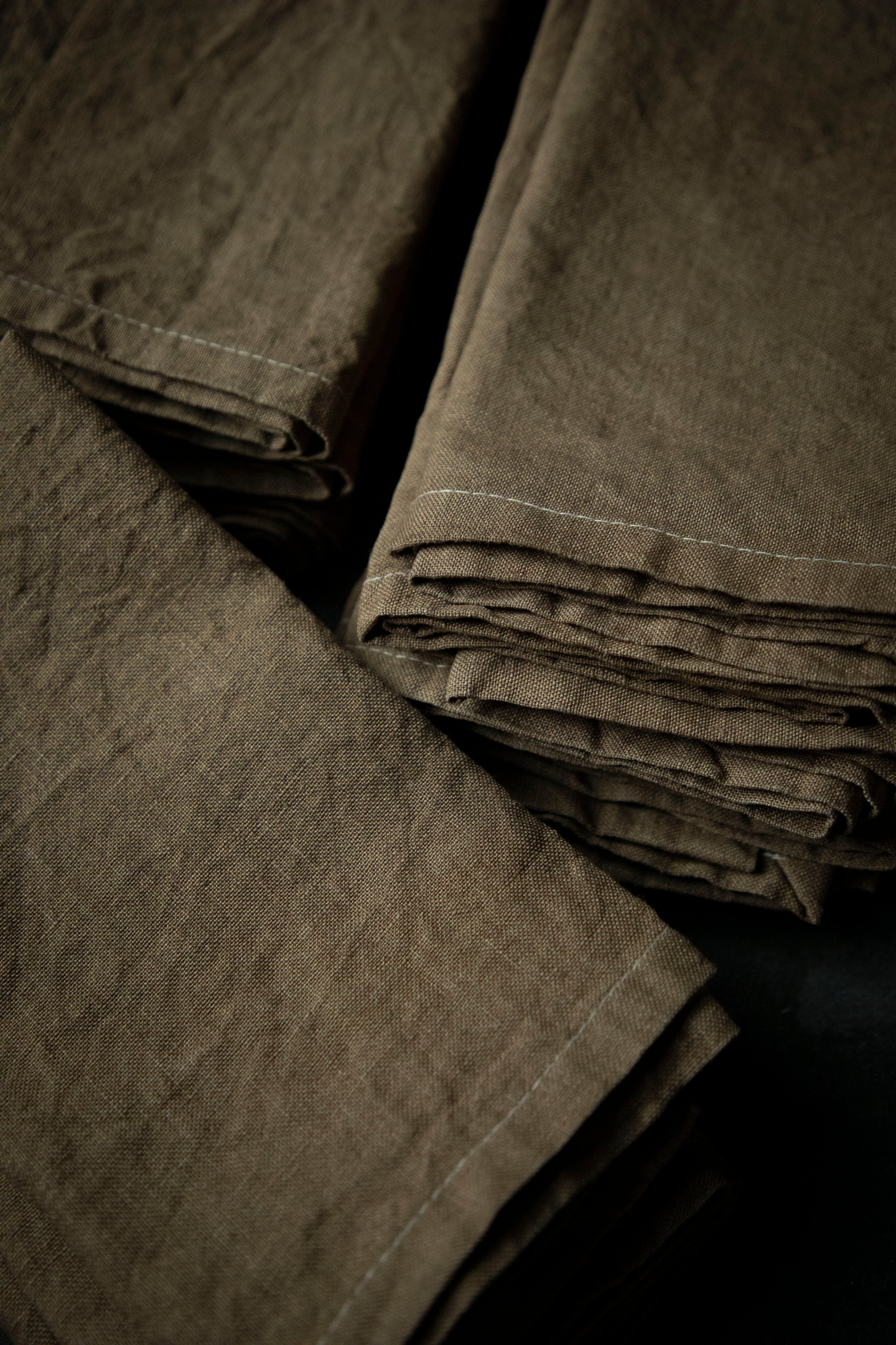 Stack of folded brown napkins on a black background
