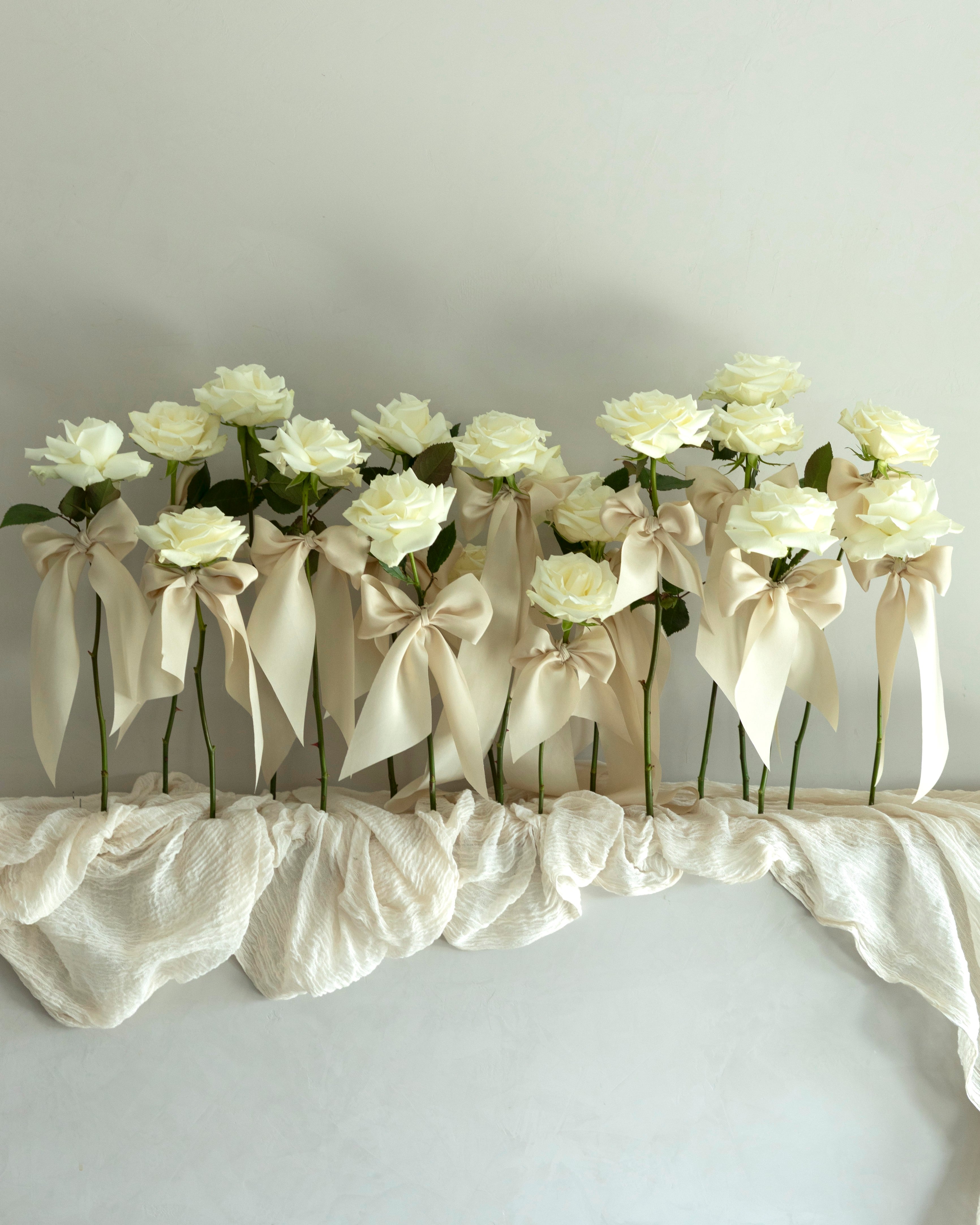 unique wedding decor. white rose stems with silk ribbons