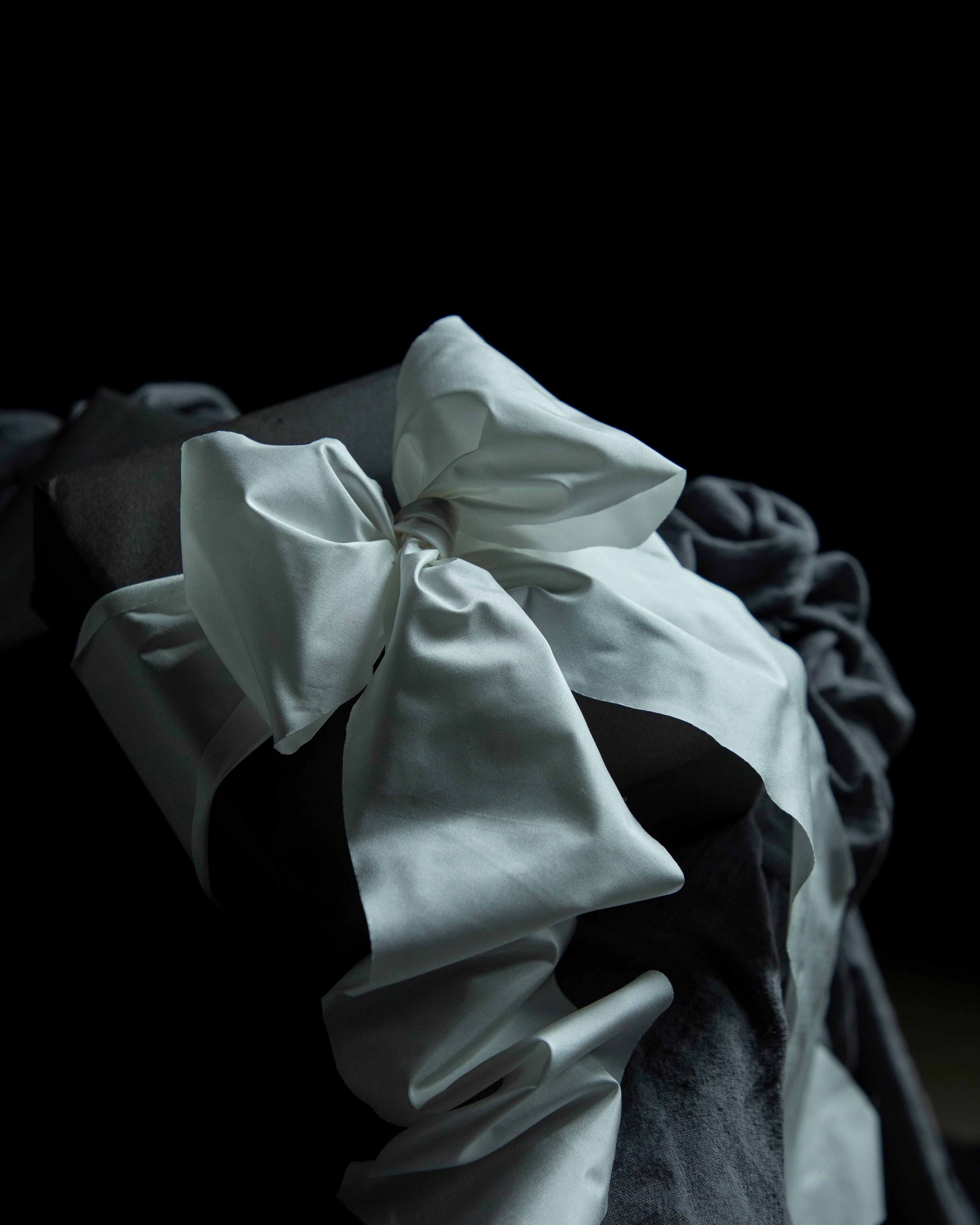 Close-up of a white ruffled fabric against a dark background