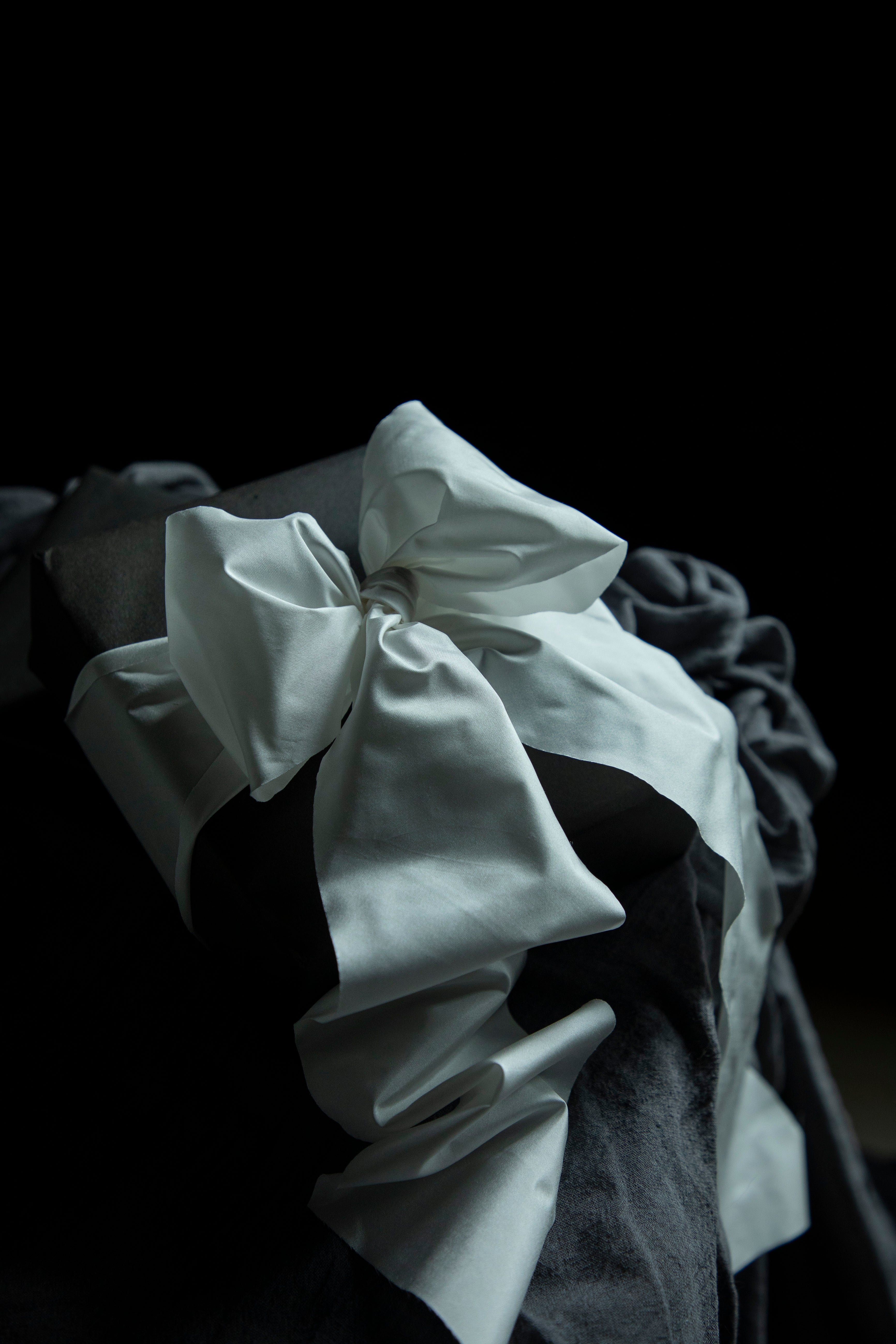 Close-up of a white ruffled fabric against a dark background