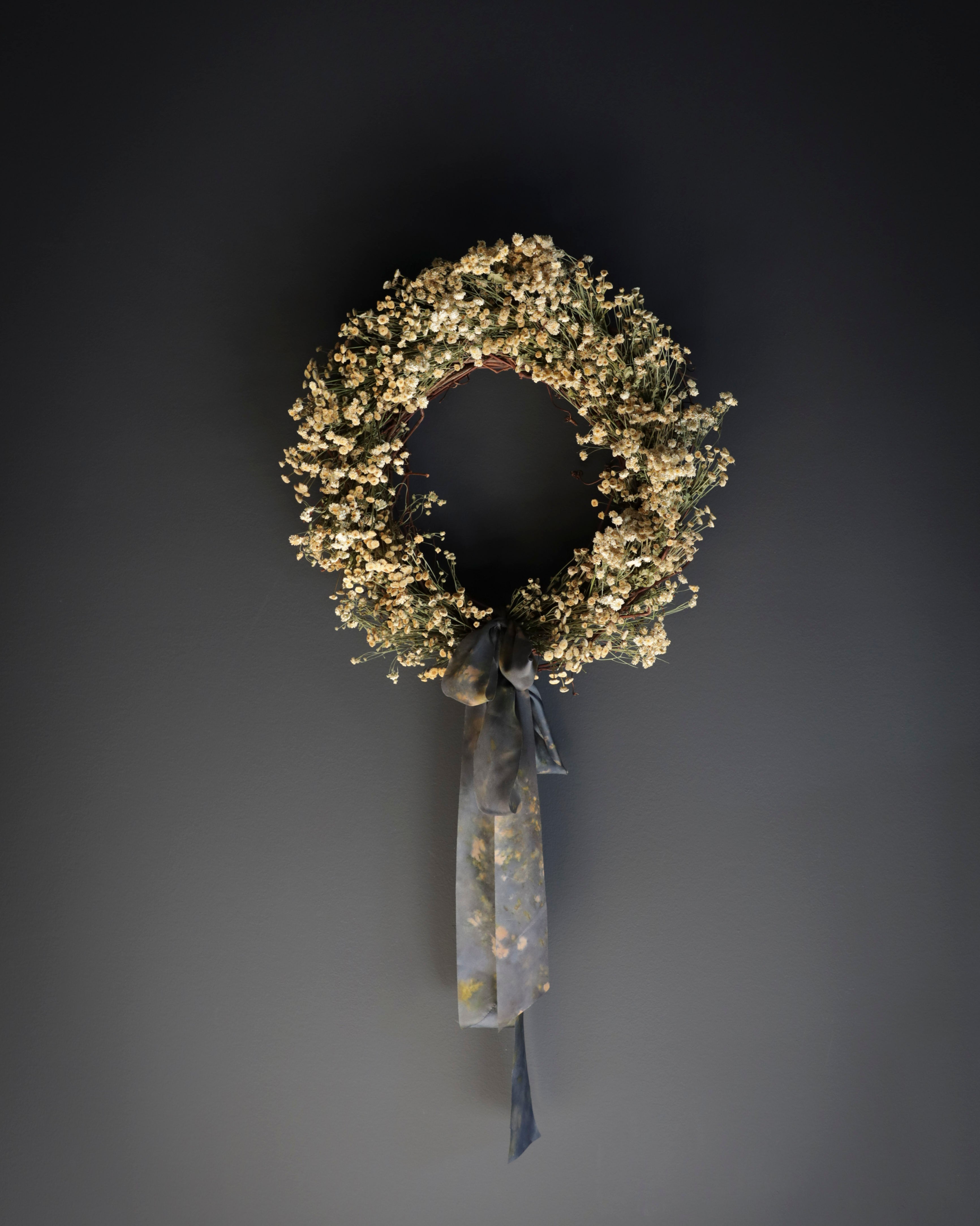 dried wreath tied with silk ribbon bow. Eco-friendly silk ribbons with nature-inspired patterns, perfect for unique gift wrapping and tying market bouquets, crafted from sustainable materials