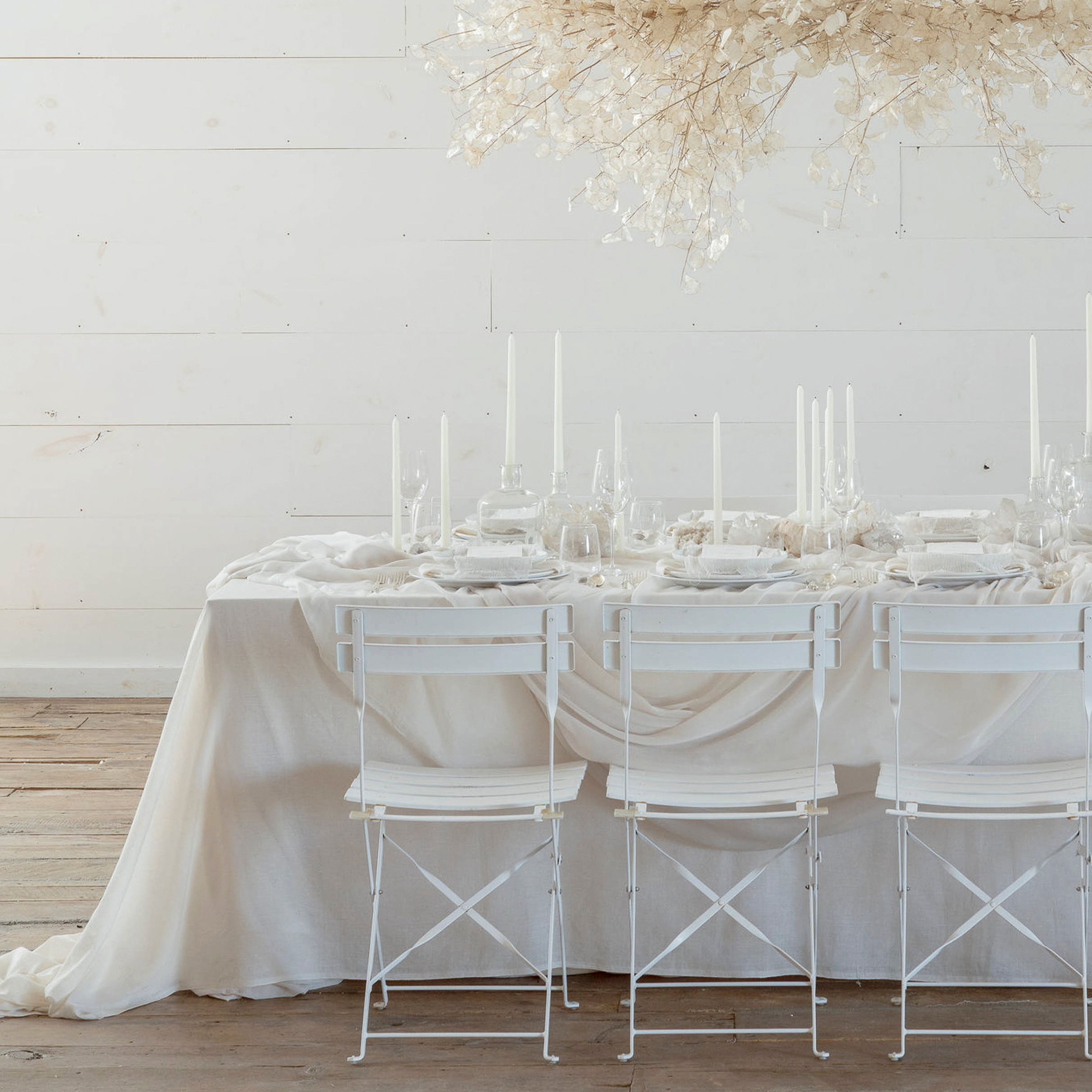 wedding table setting with monochromatic white table decor