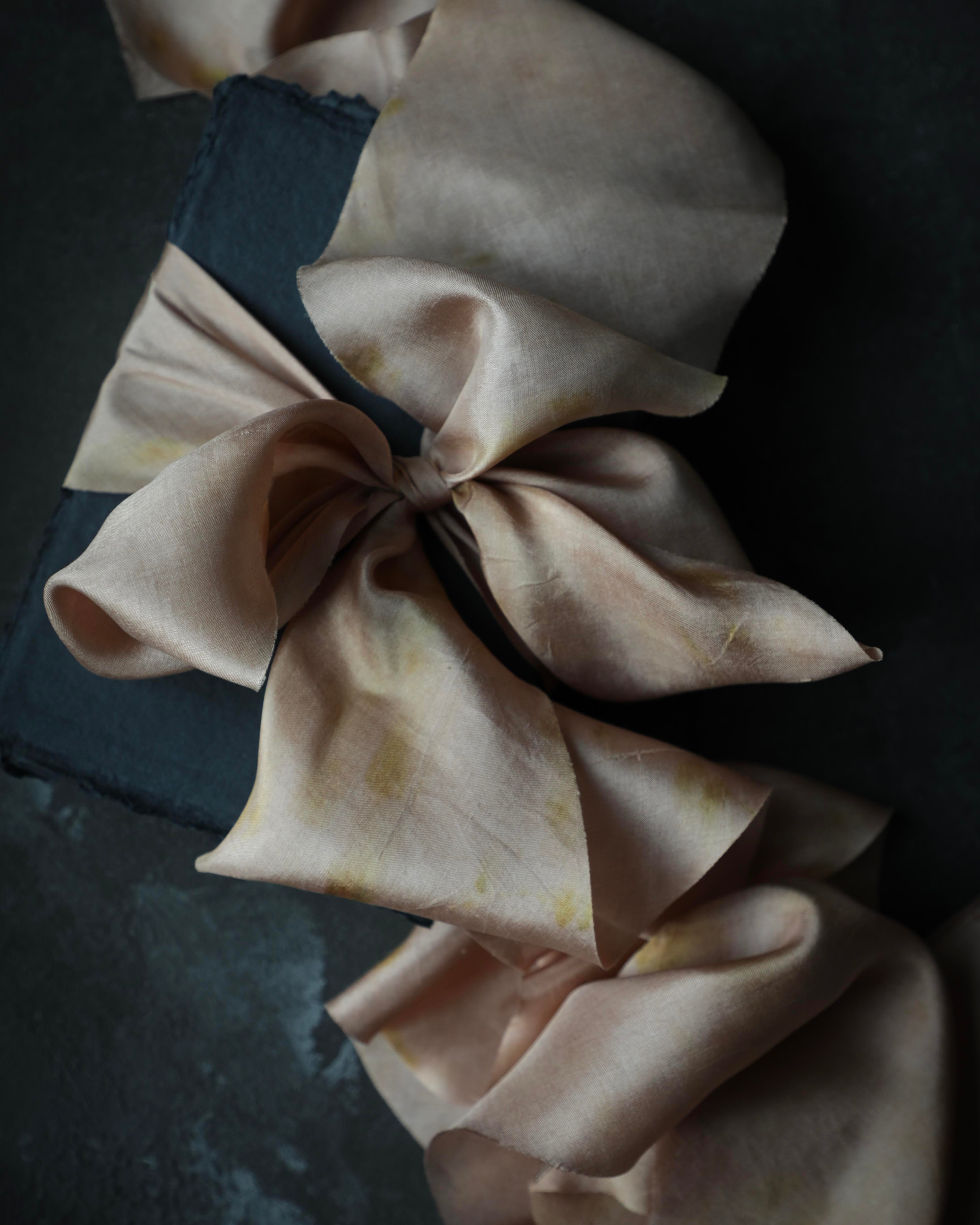 handmade paper for custom wedding invitations with plant dyed silk ribbon