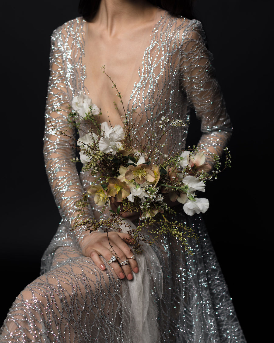 Bride holding a wedding boquet tied with silk ribbon