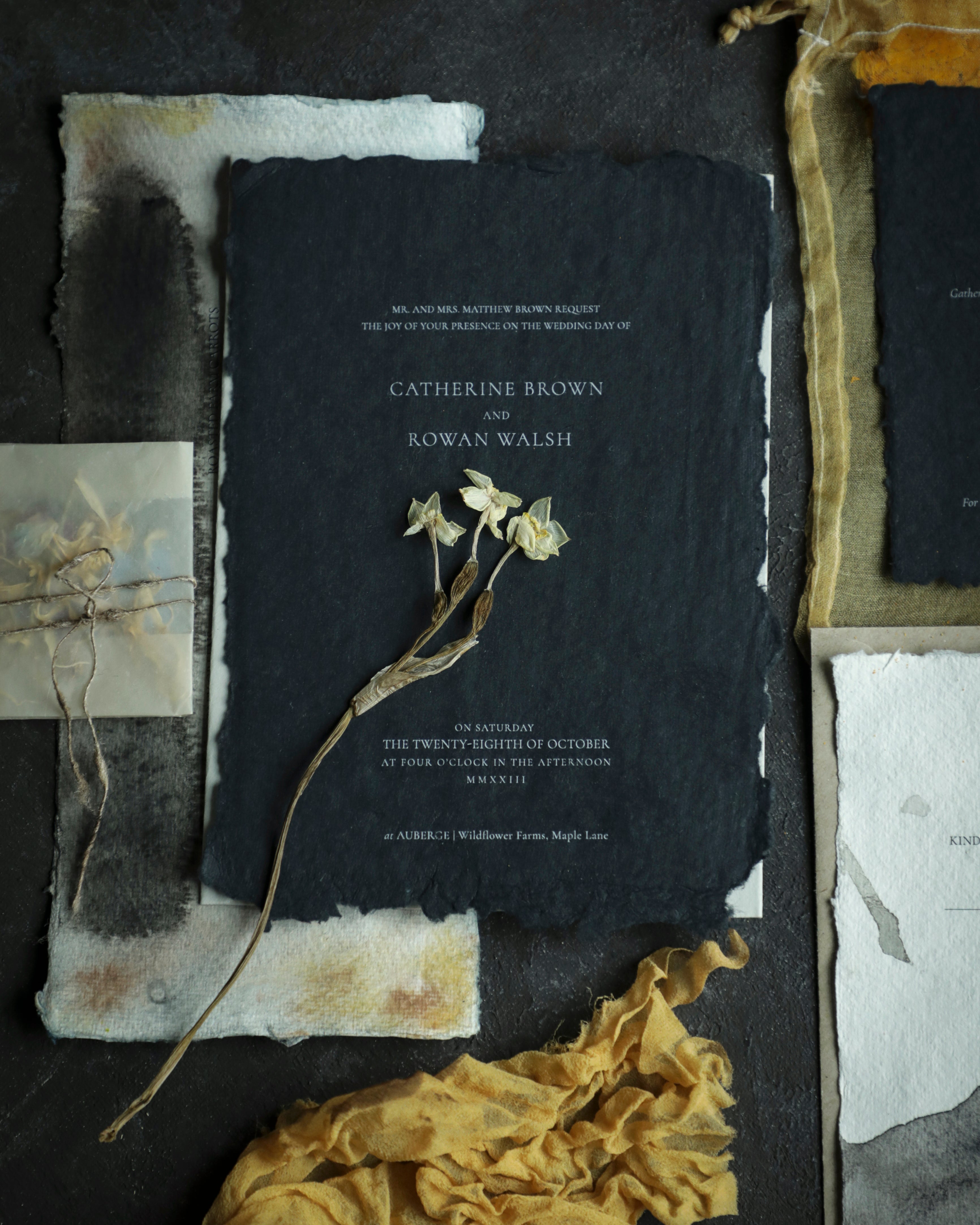 wedding invite on black handmade paper and white ink toner