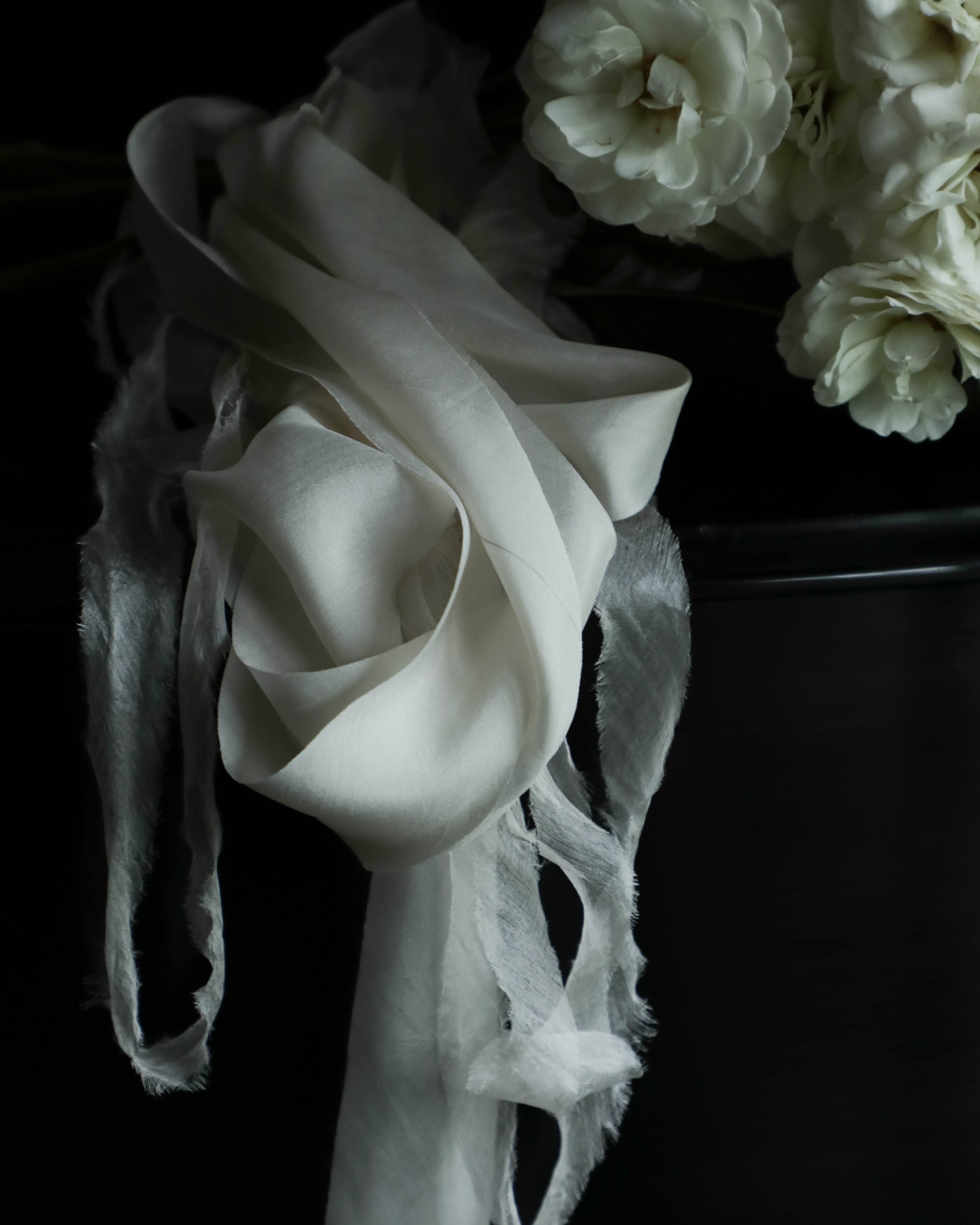 white roses with white organic silk ribbon on a steinway paino