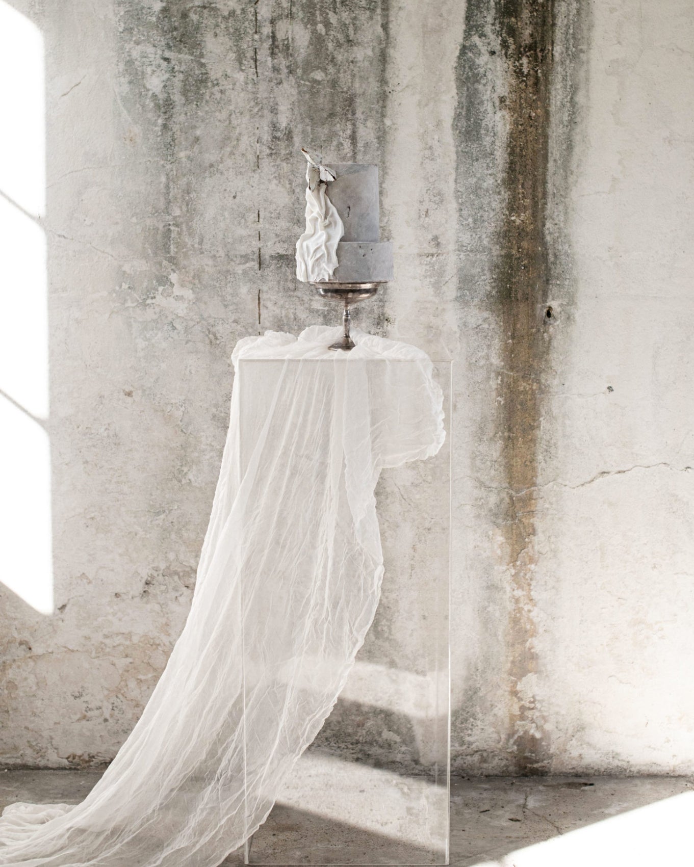 white sheer silk draping from a pedestal display with wedding cake by Marina Machado