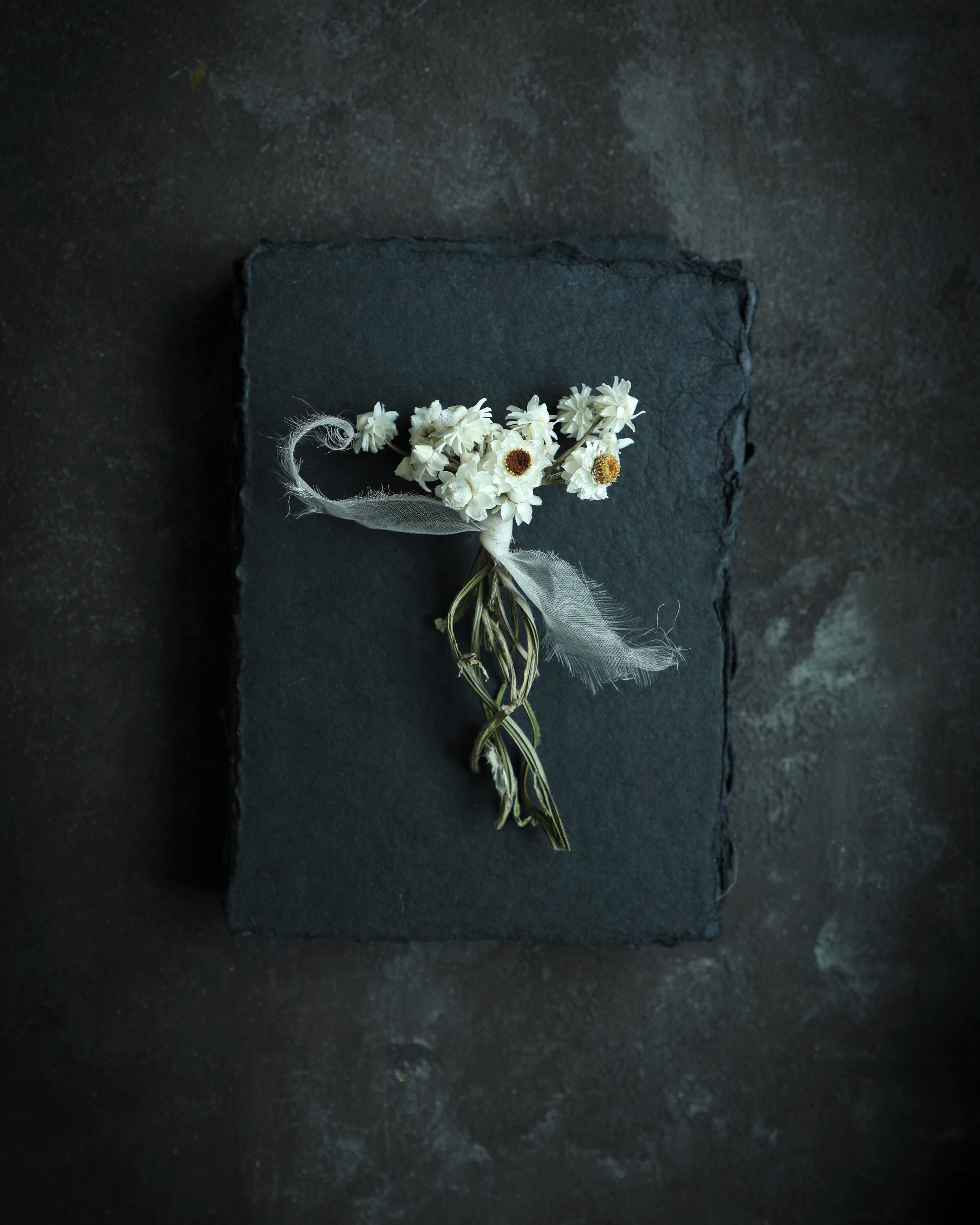 dried flowers on black handmade paper