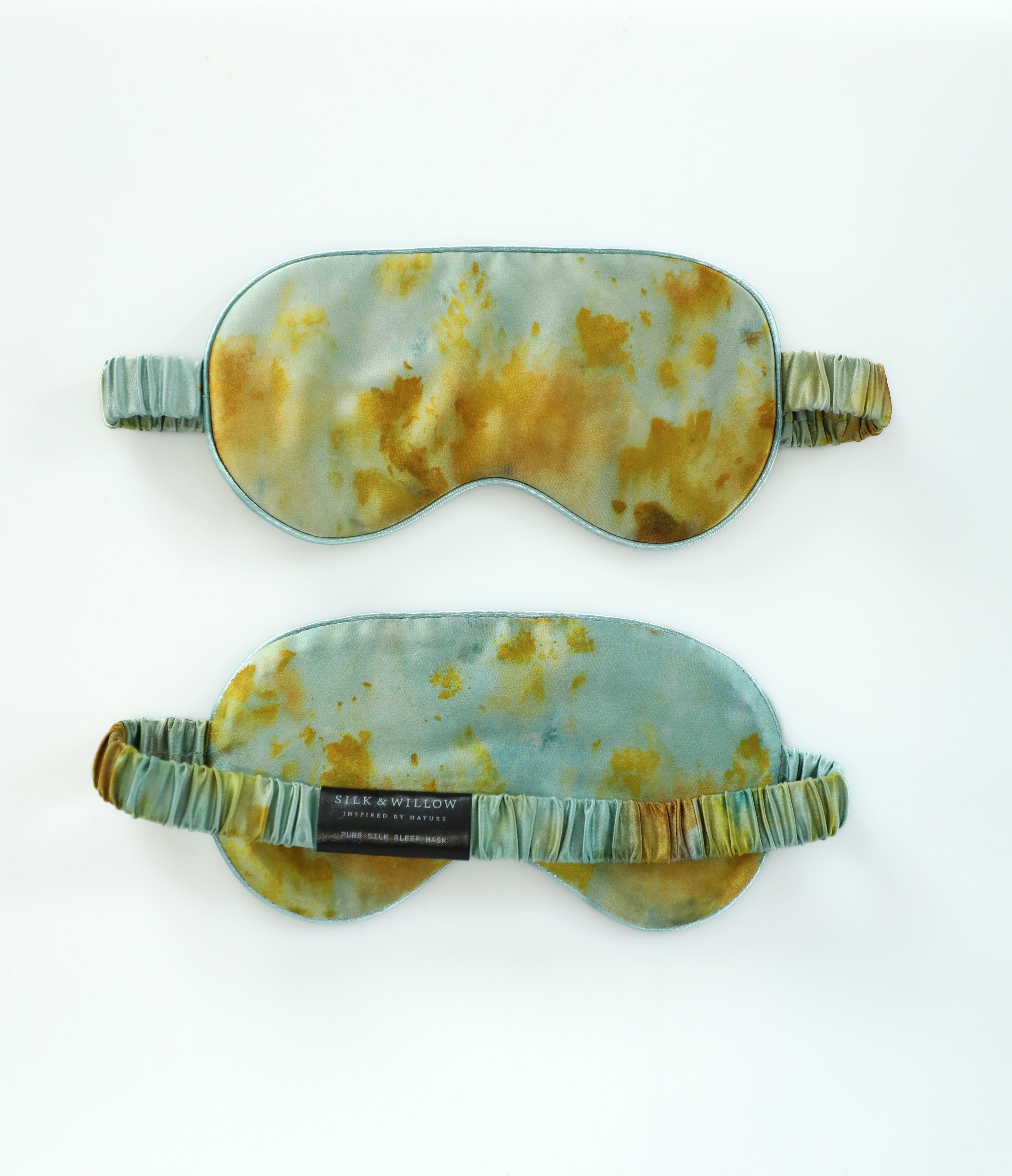 Two marbled-patterned sleep eye masks on a white background