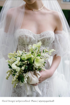 bride holding lily of the valley bridal bouquet wrapped with silk and willow silk ribbon