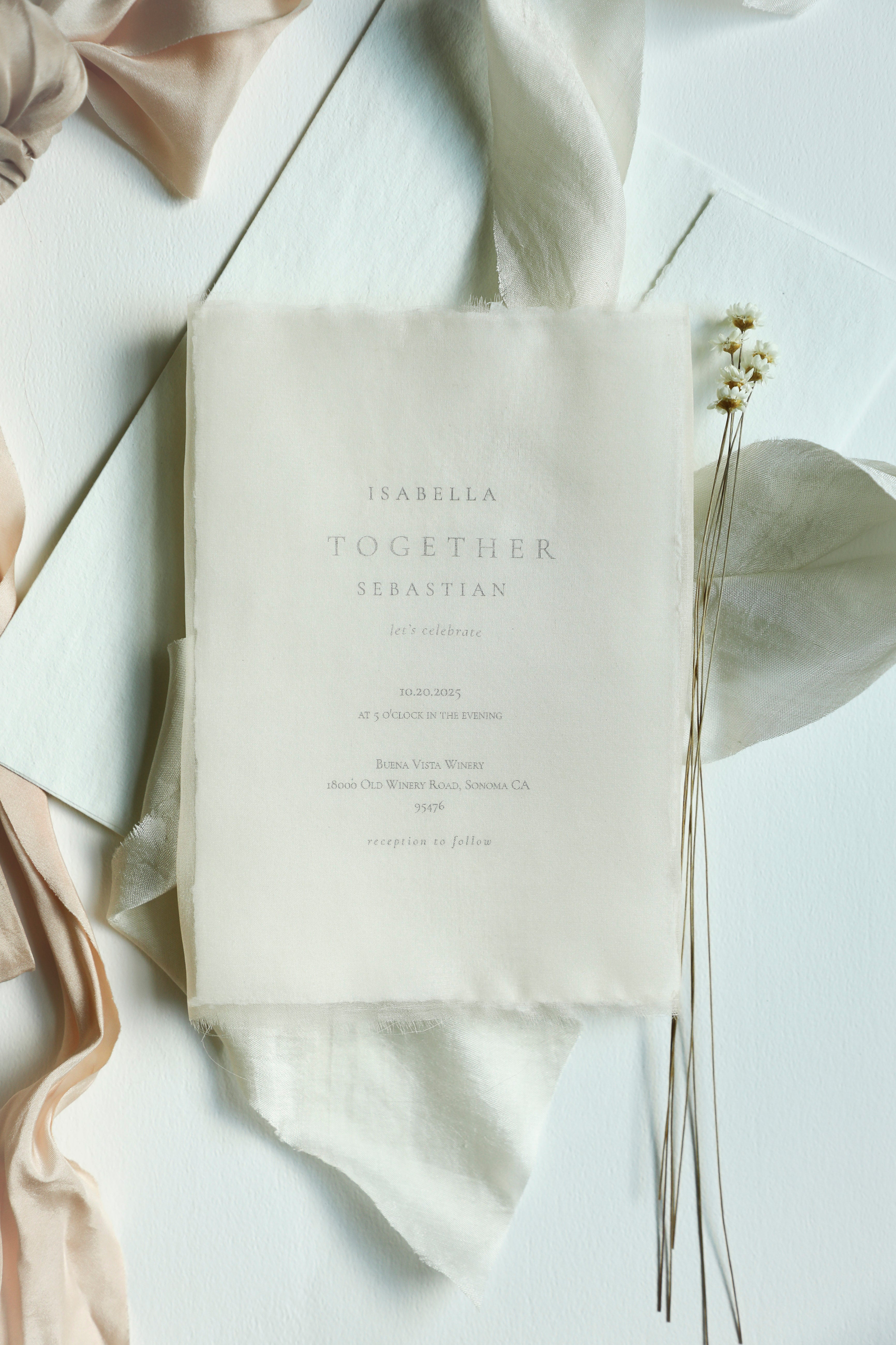 White wedding invitation with text on a light background with flowers