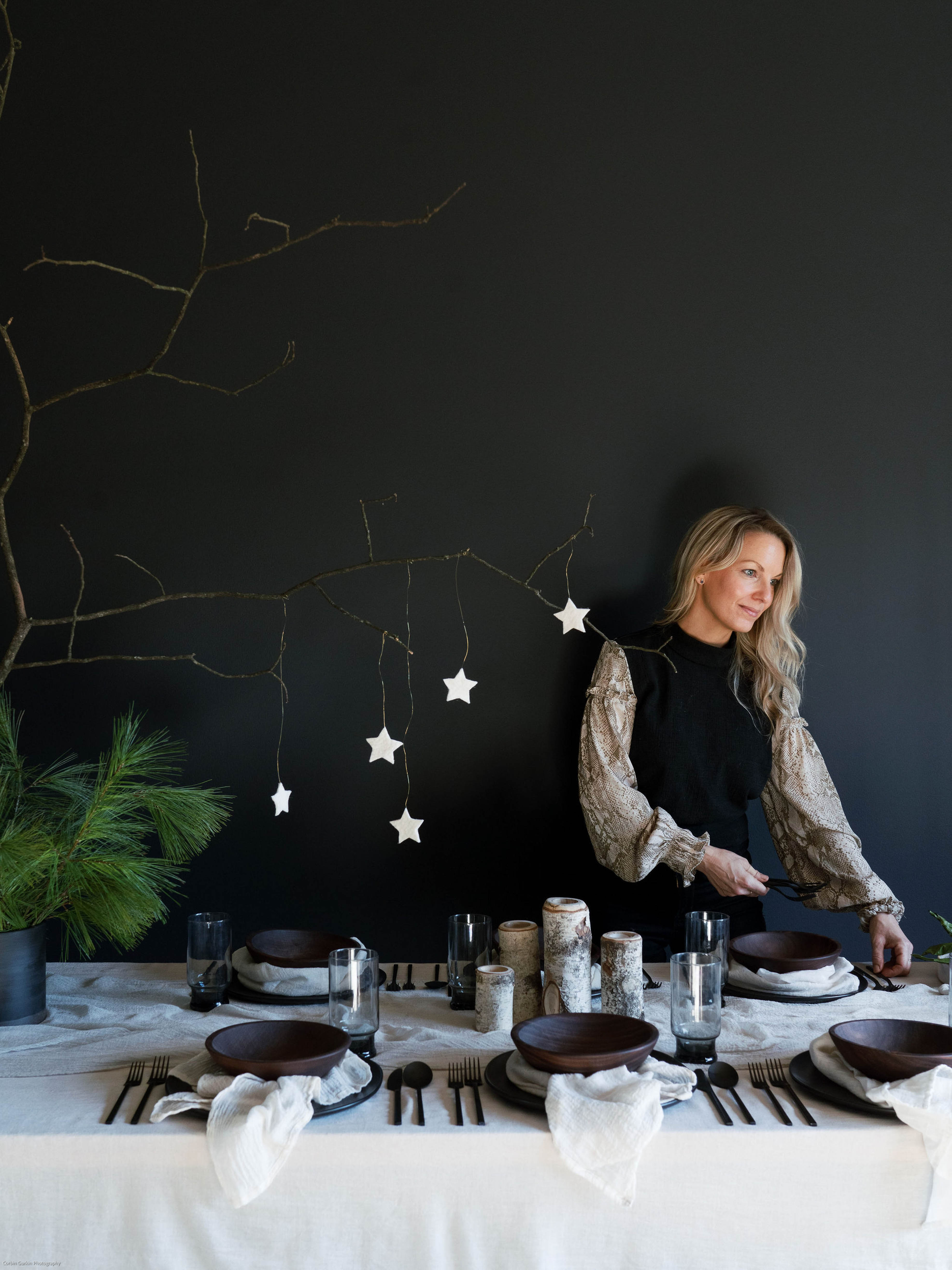 An elegantly set Nordic winter table featuring antique white, plant-dyed, handloomed cotton napkins, showcasing a wabi-sabi, organic design that highlights the heirloom quality of the table linens. Perfect for anyone seeking to create a serene and sophisticated winter tablescape.
