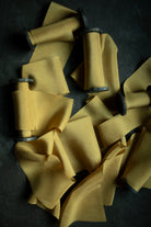 Yellow ribbon with on black spools on a dark surface