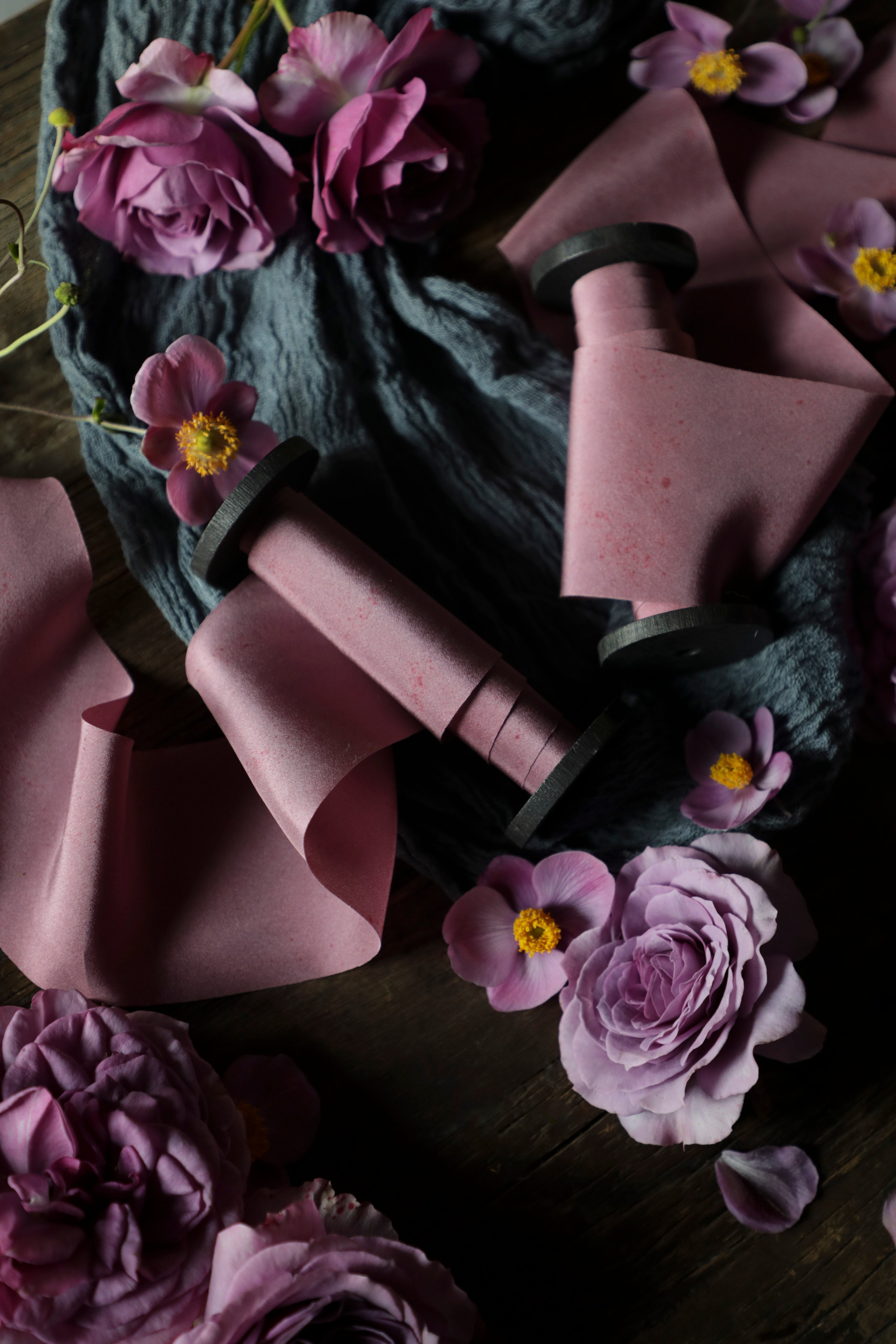 mauve silk ribbon in a flatlay styling on wood backdrop