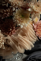 Close-up of a bouquet of flowers with a neutral color palette.