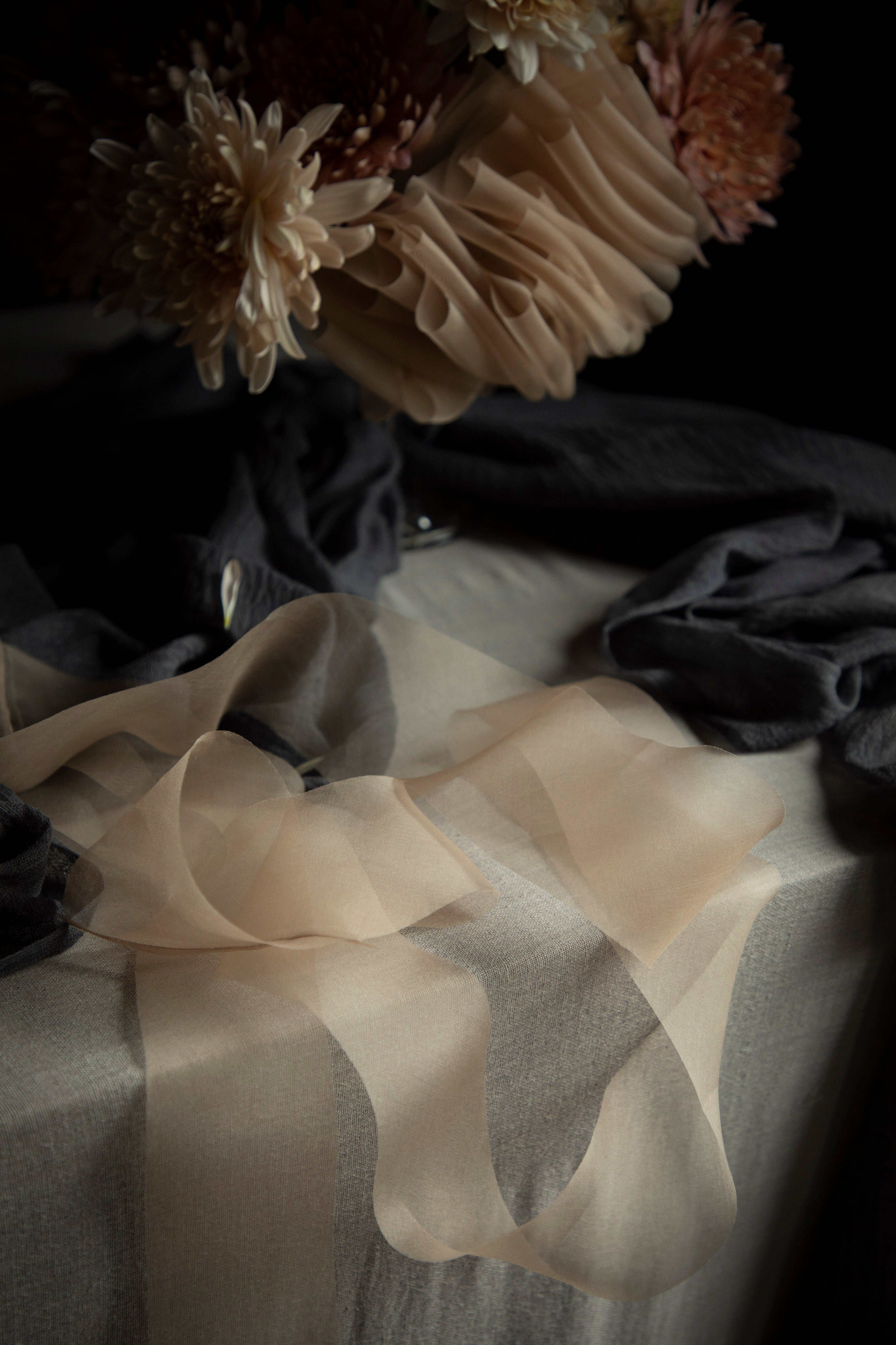 Close-up of a bouquet with flowers and ribbons on a dark background