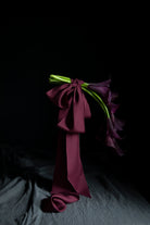 floating purple calla lily flowers tied with purple ribbon bows
