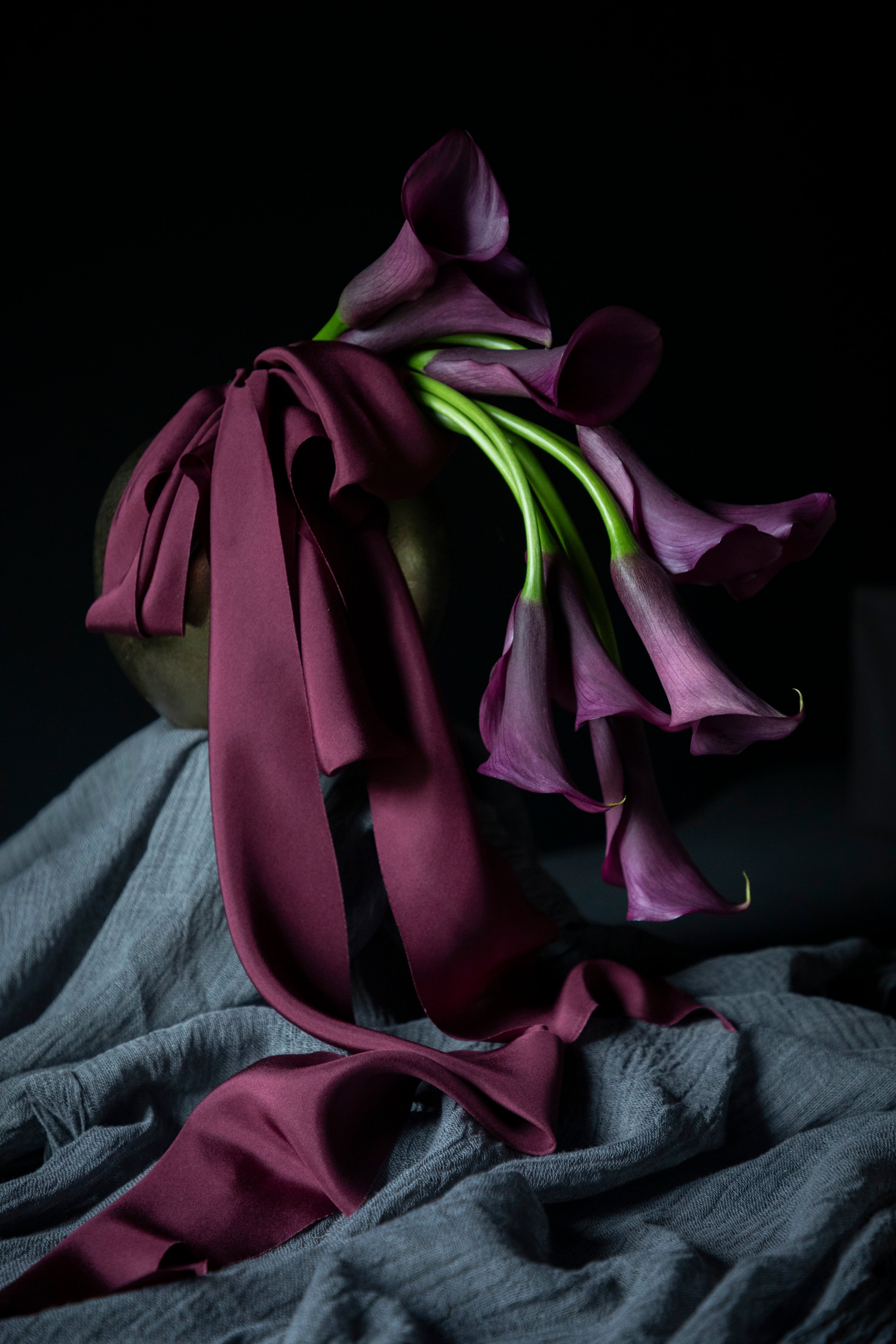 purple calla lily flower arrangement with purple silk ribbon
