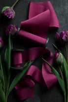 hot pink silk ribbon on a black background with tulip flowers