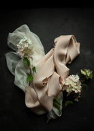 Ruffled beige fabric with flowers on a dark background