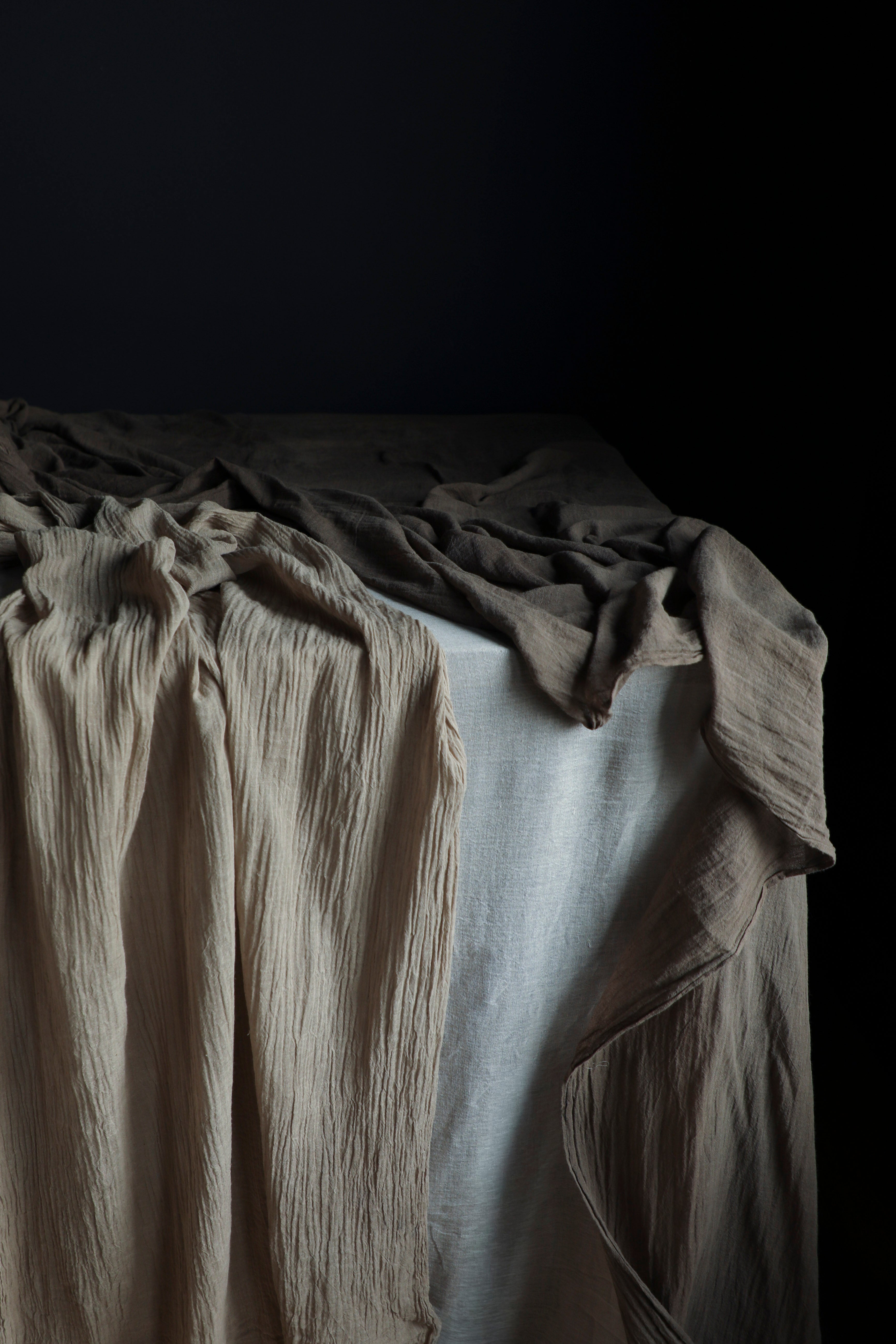 Textured fabric draped over a surface with a dark background