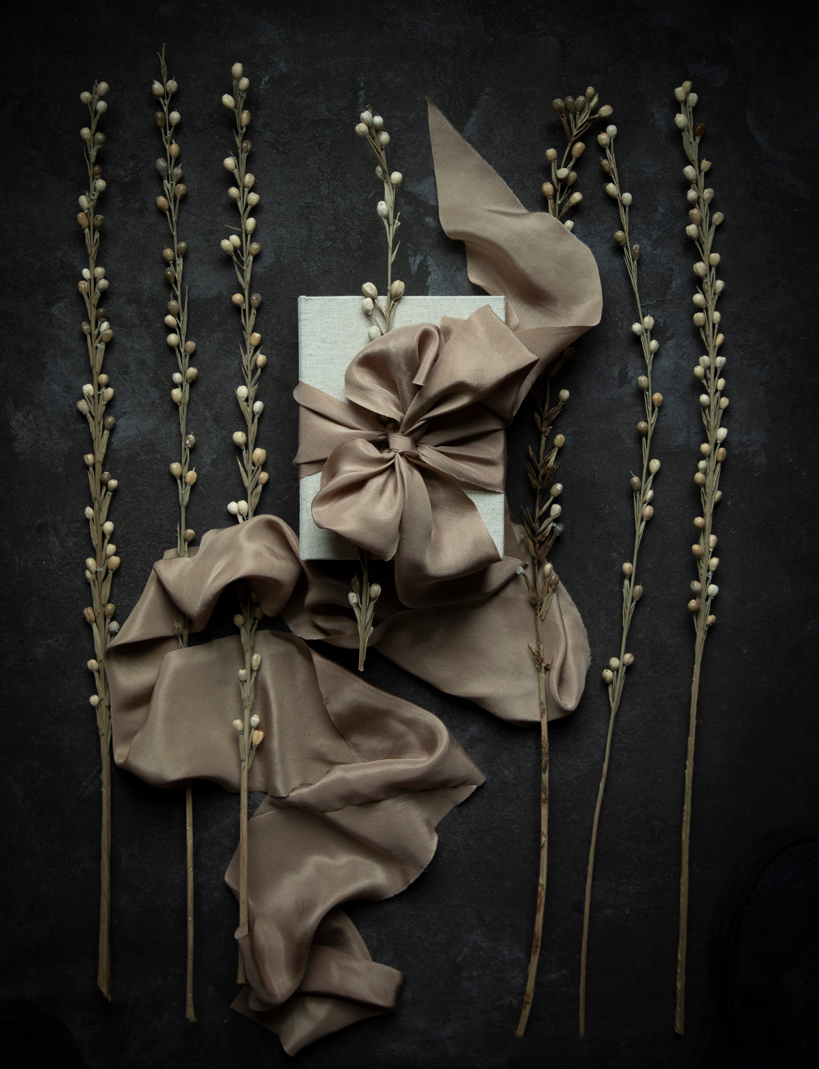 Decorative arrangement with ribbons and twigs on a dark background