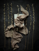 Decorative arrangement with ribbons and twigs on a dark background