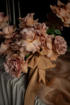 Bouquet of flowers with ribbons on a dark background