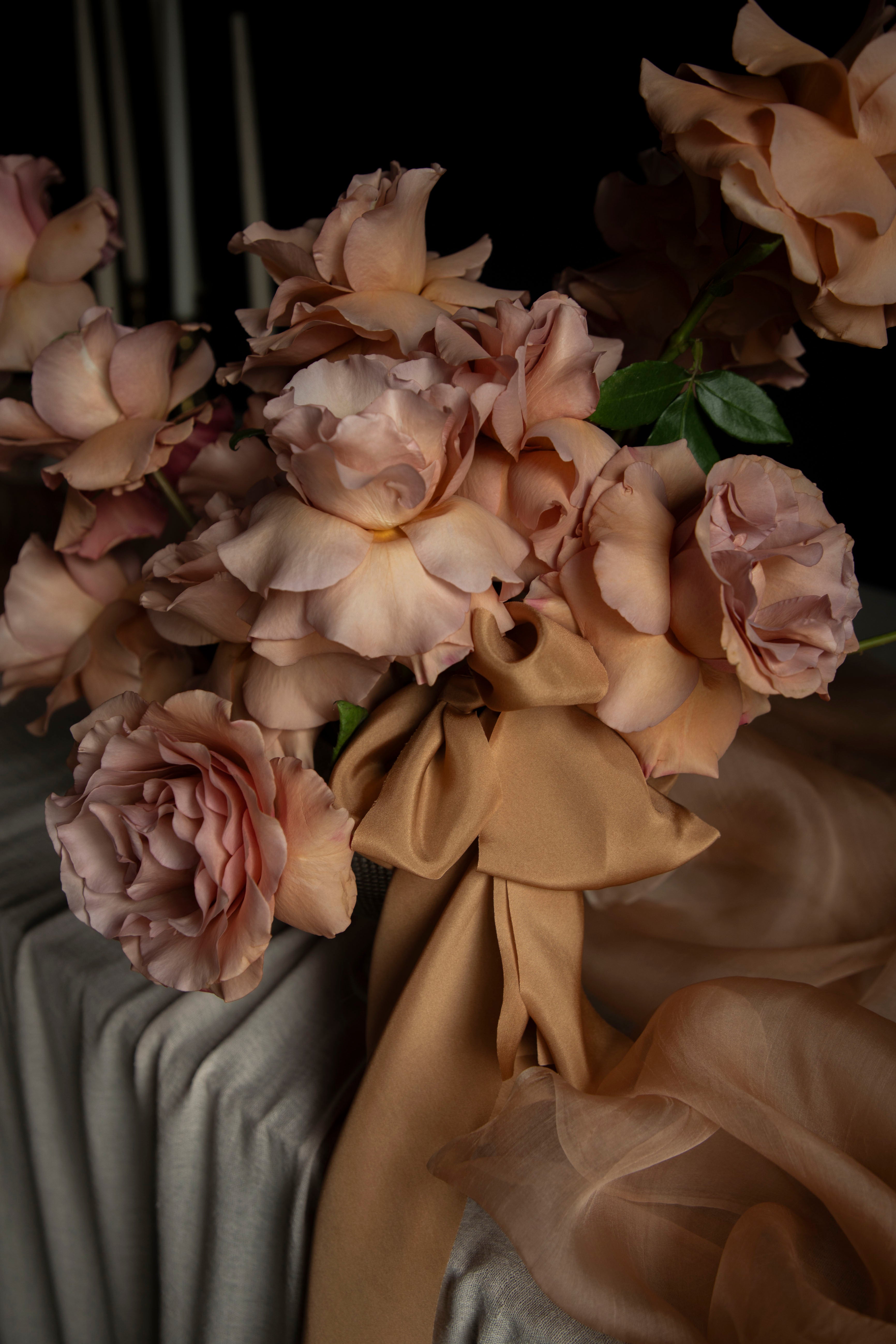 Bouquet of flowers with ribbons on a dark background
