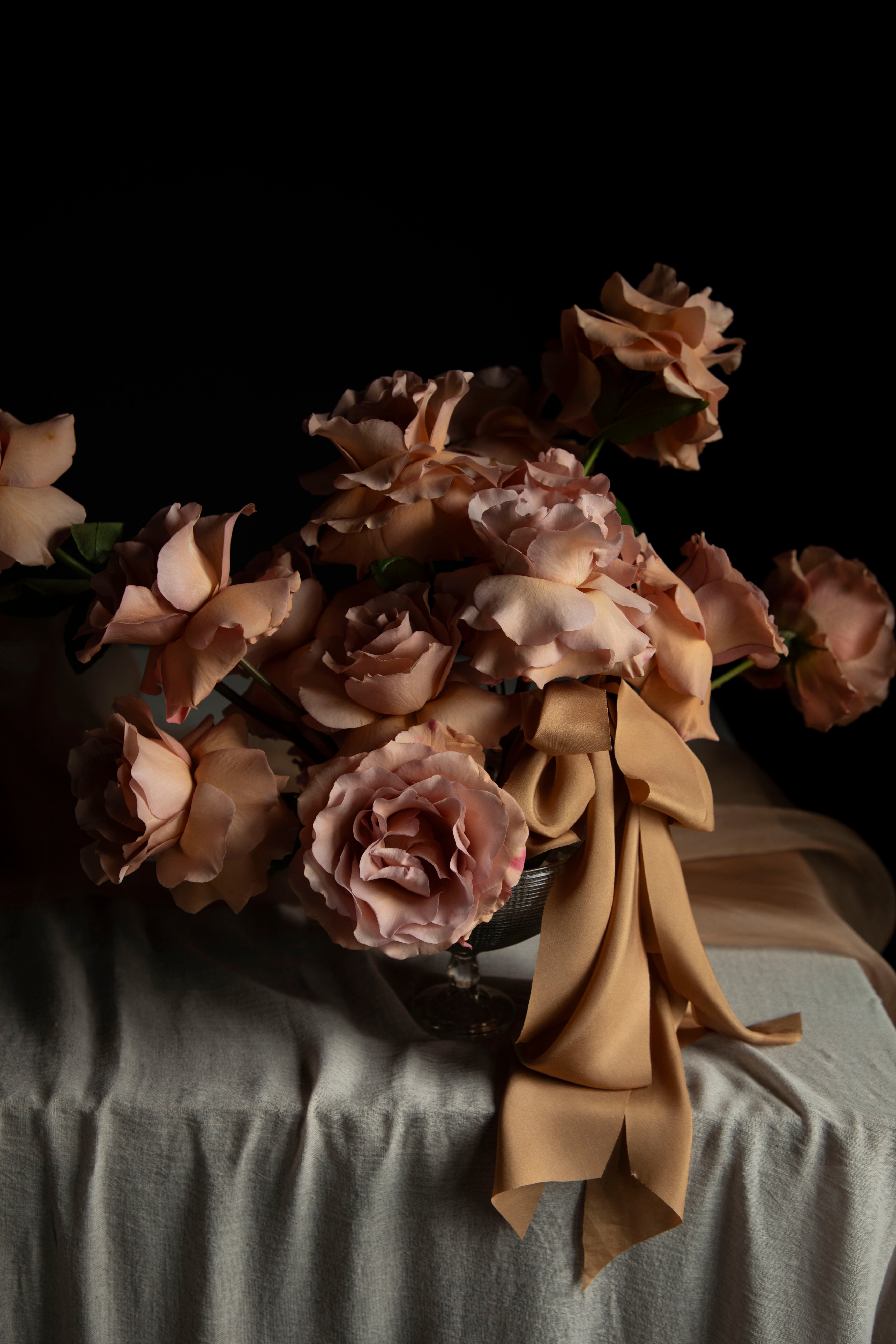 Bouquet of flowers with a brown ribbon on a dark background