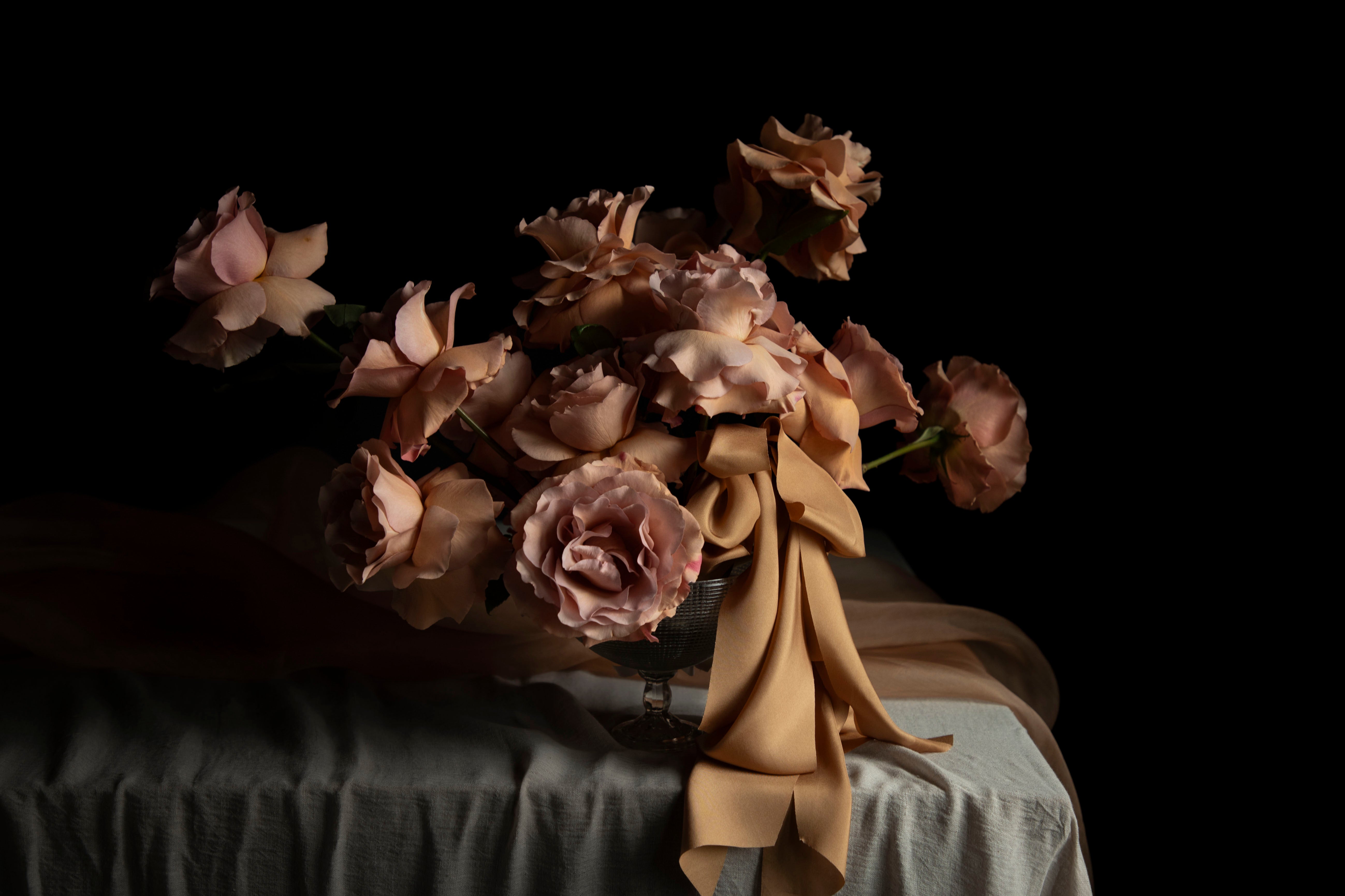 floral centerpiece on a wedding table with draped textiles with a dark background