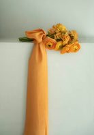 Orange ranunculus flower bouquet with orange silk ribbon