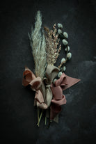 dried fall plants with ribbon bows