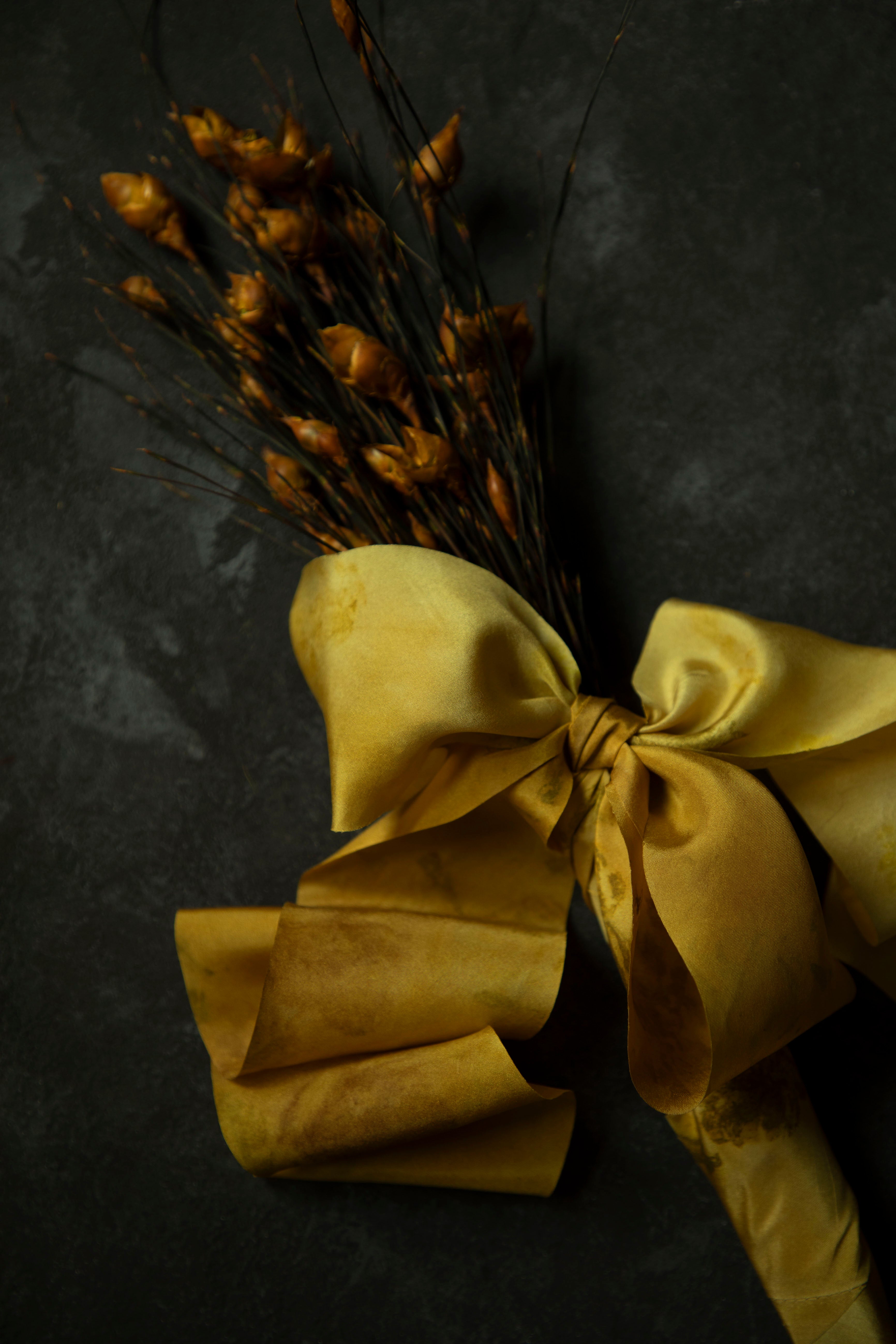 dried bouquet tied with gold silk ribbon